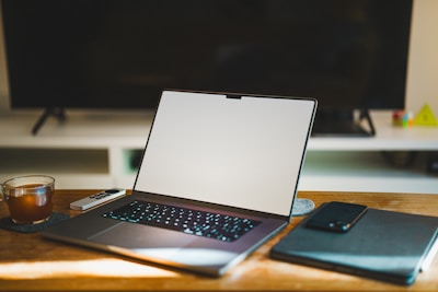 A laptop computer sitting on top of a wooden desk