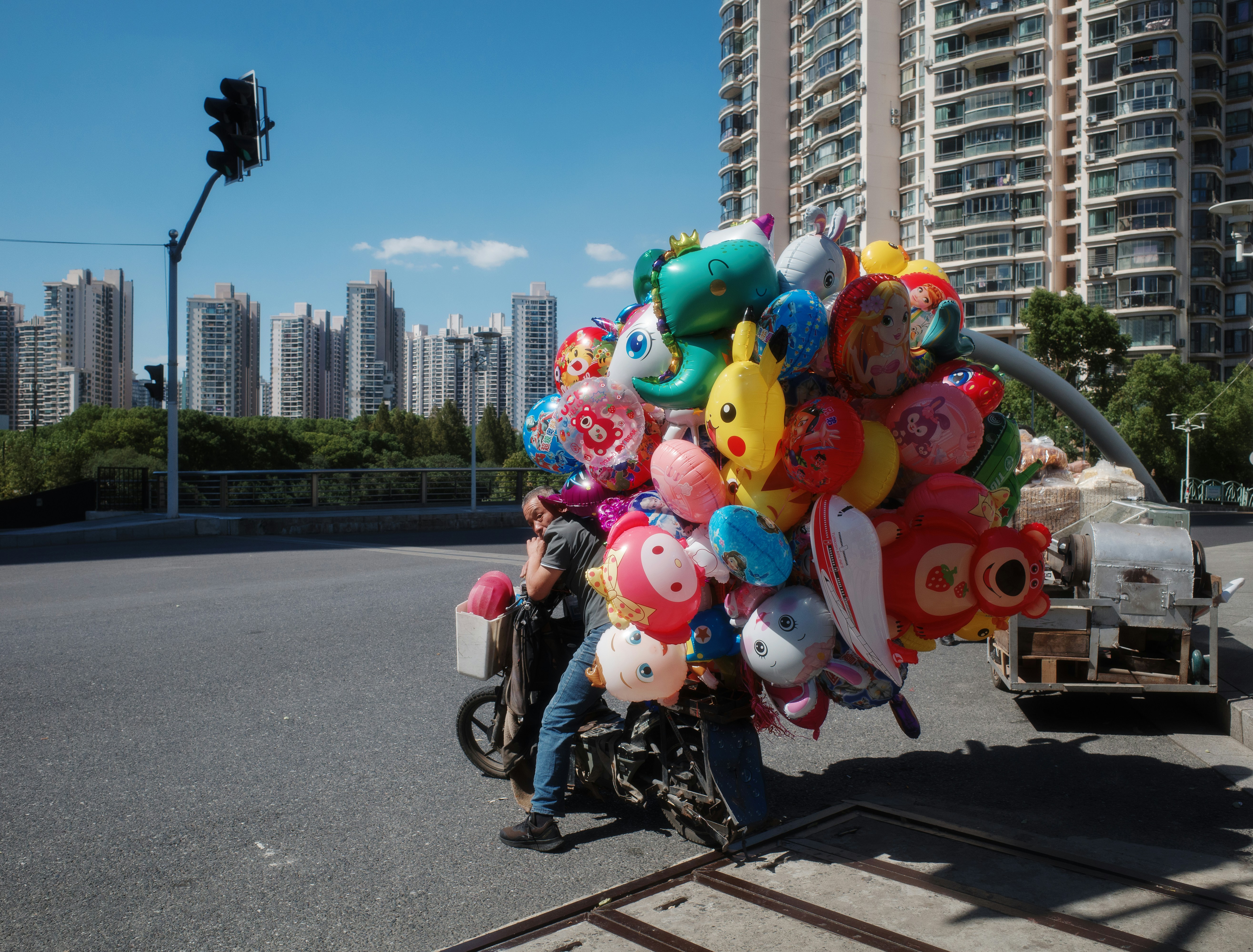 A motorcycle with a bunch of balloons on the back of it