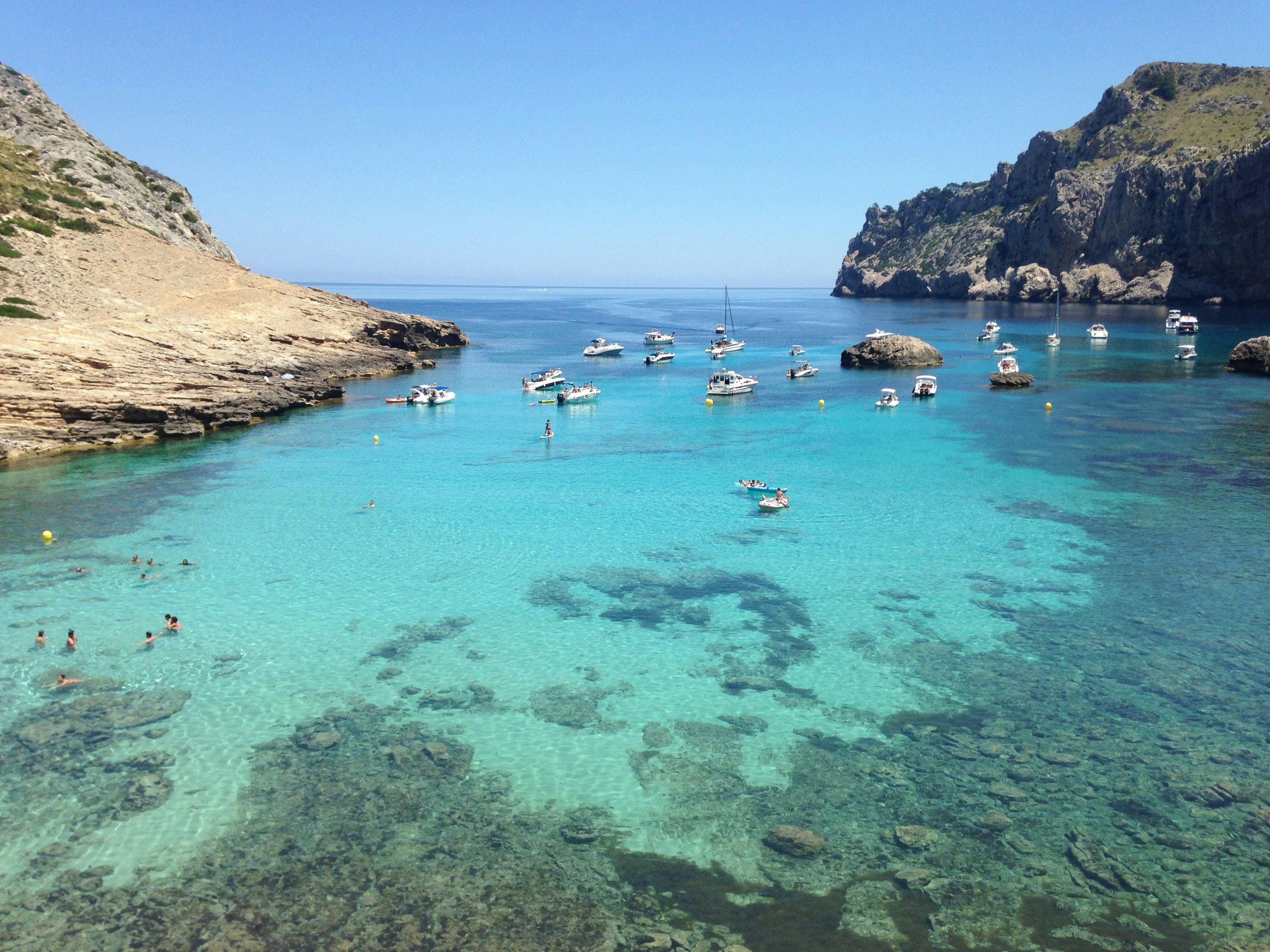 A group of boats floating on top of a body of water