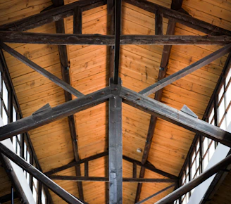A view of a wooden ceiling with beams