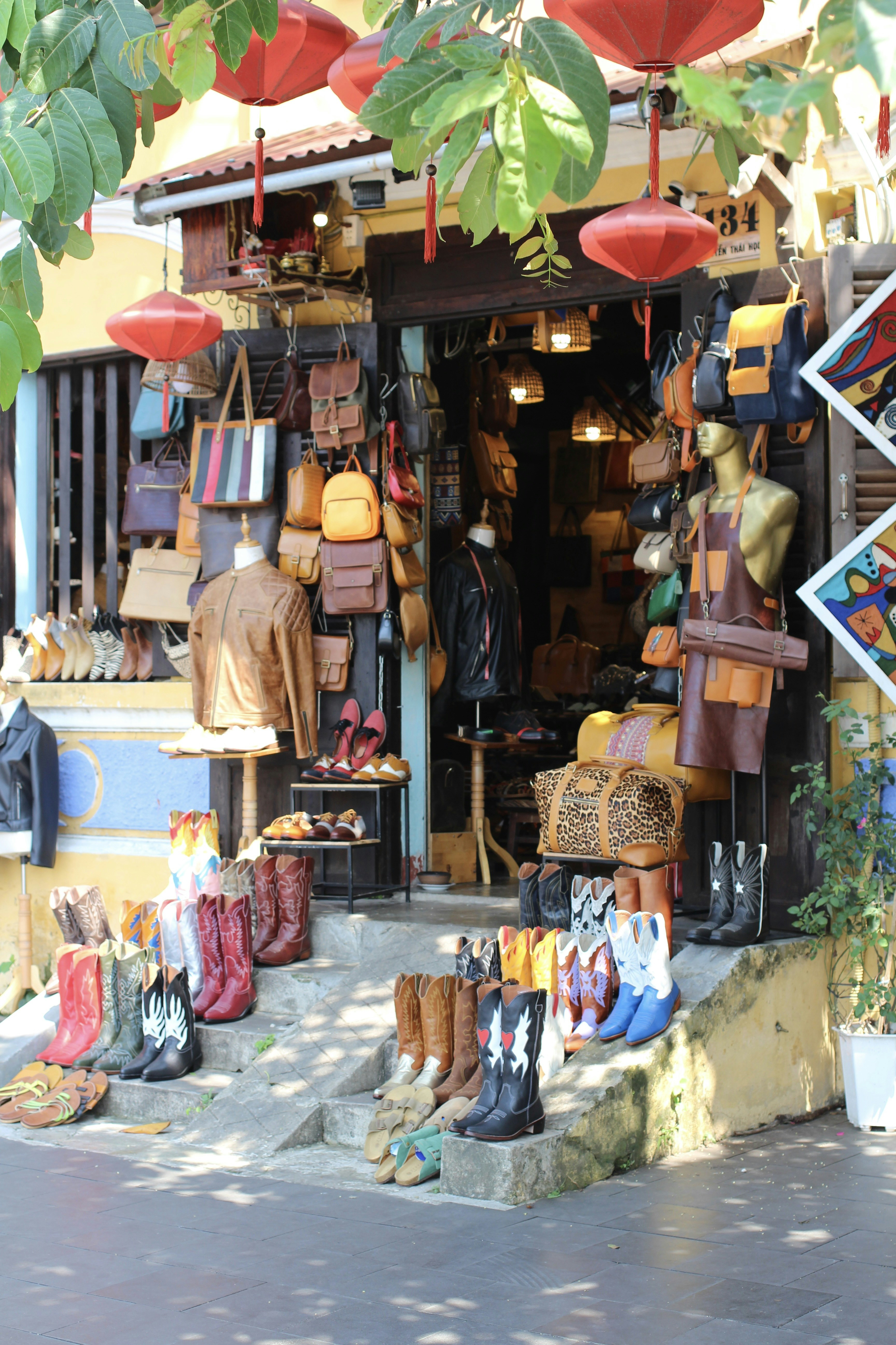 A store front with a lot of boots and umbrellas