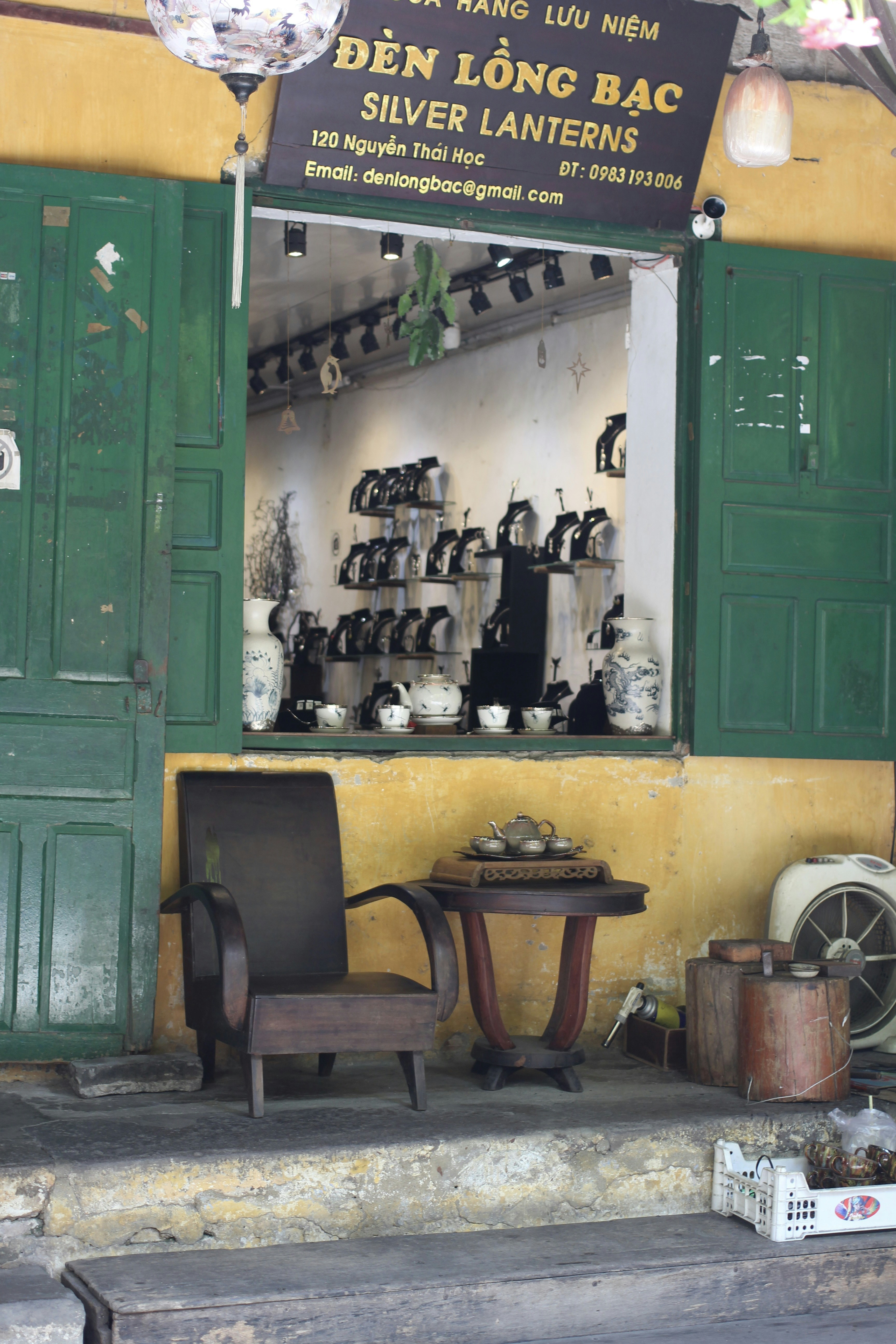 A store front with green doors and green shutters
