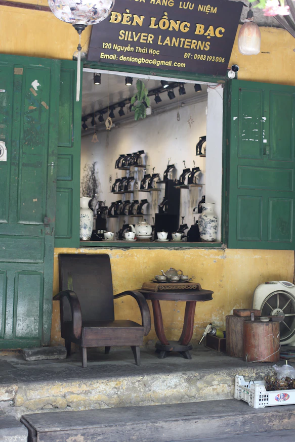A store front with green doors and green shutters
