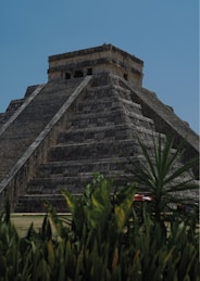 A tall pyramid with a clock on top of it