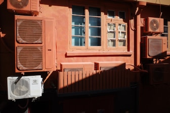 A building that has a bunch of air conditioners on it