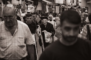 A black and white photo of a crowded street