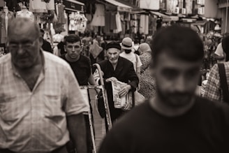 A black and white photo of a crowded street