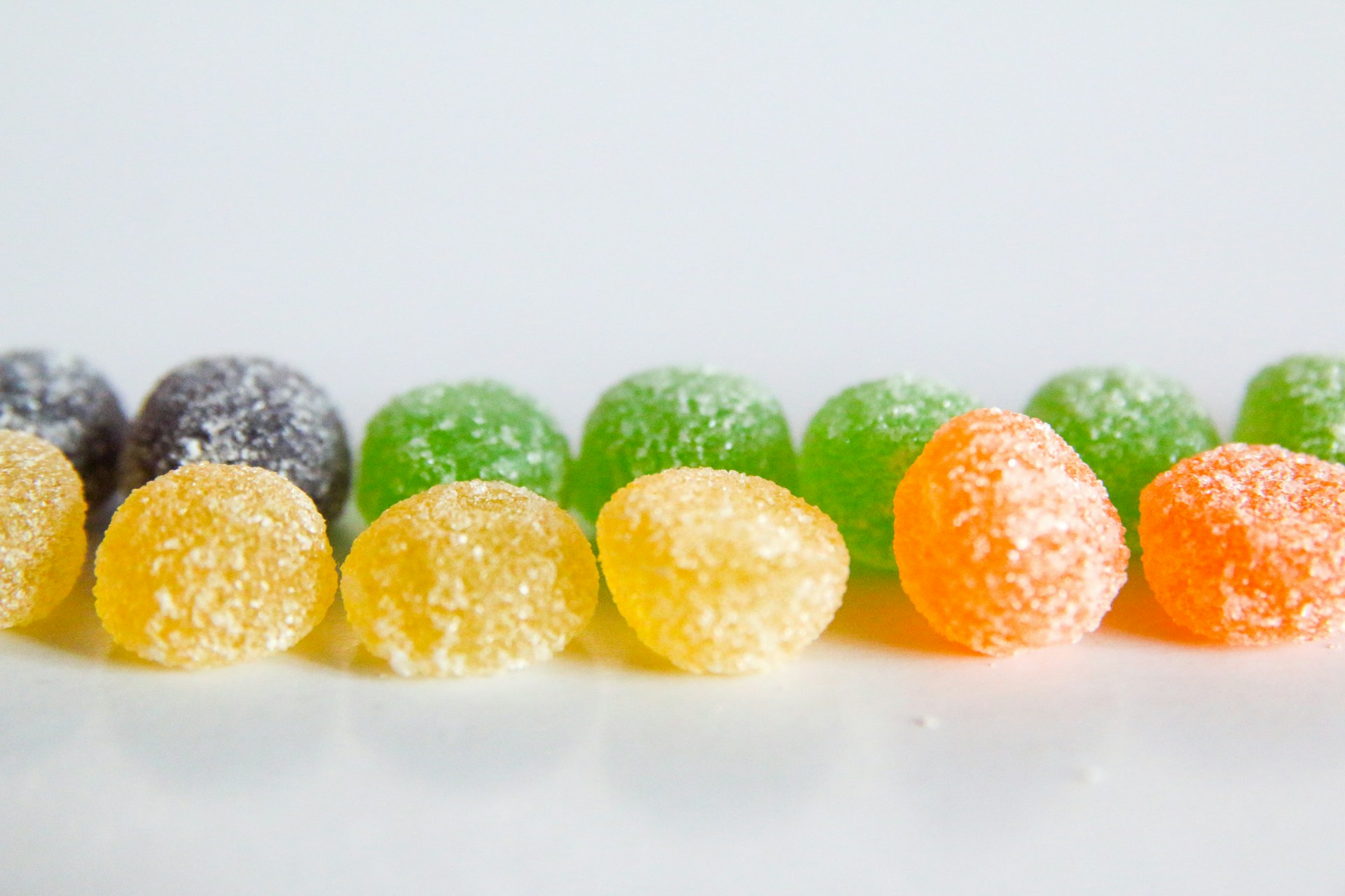 A row of different colored candies sitting next to each other