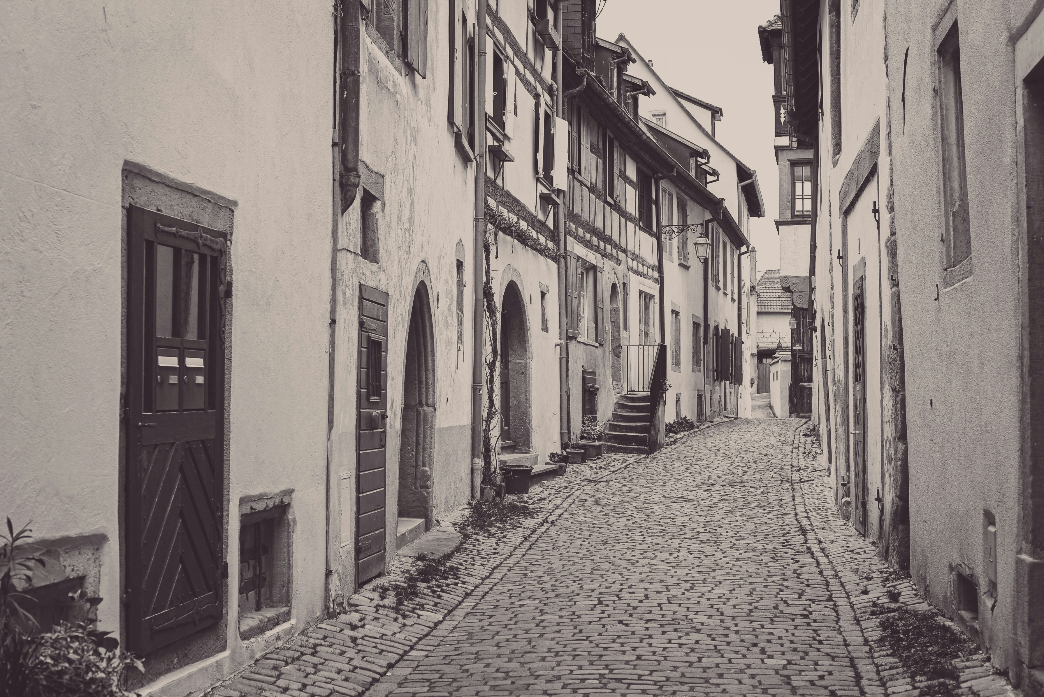A black and white photo of a cobblestone street