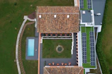An aerial view of a house with a swimming pool
