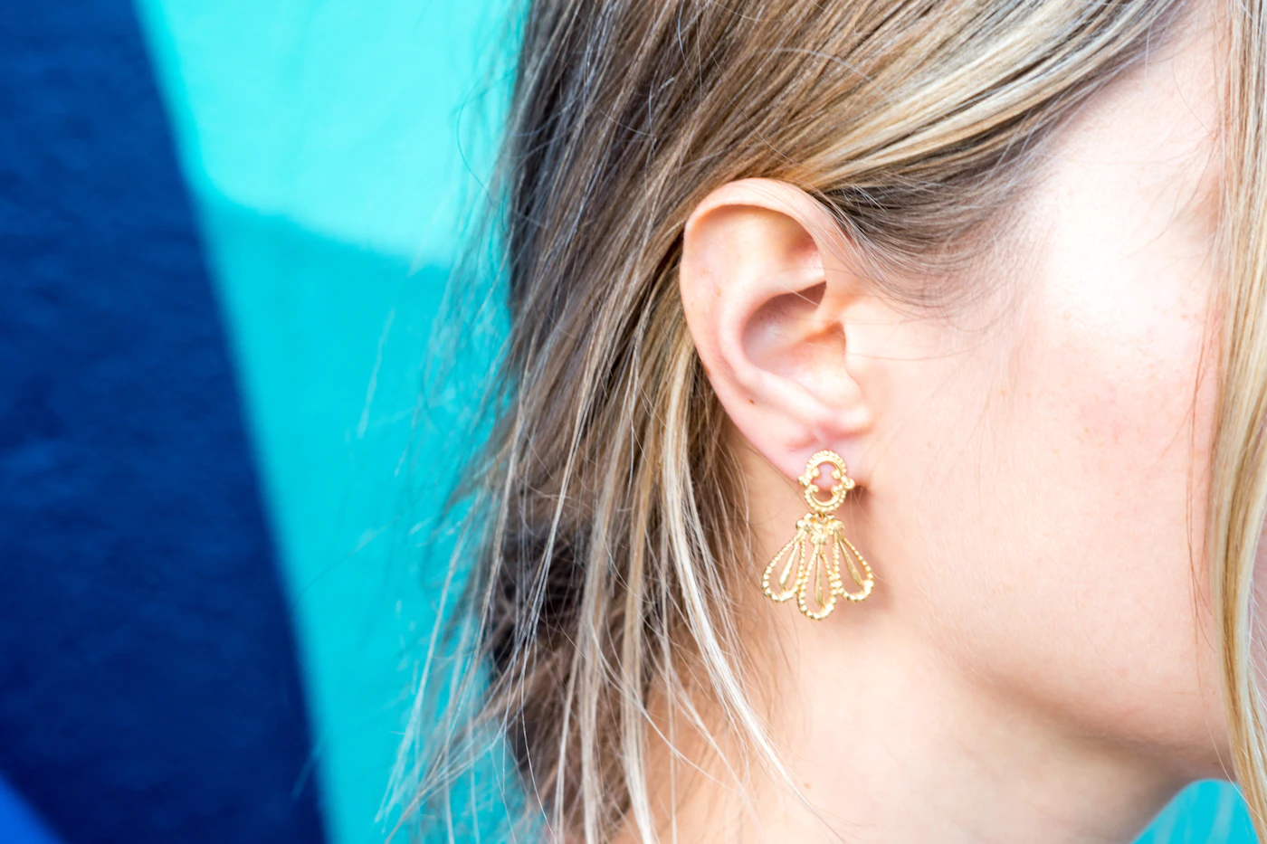 Close up of a person wearing small stud earrings