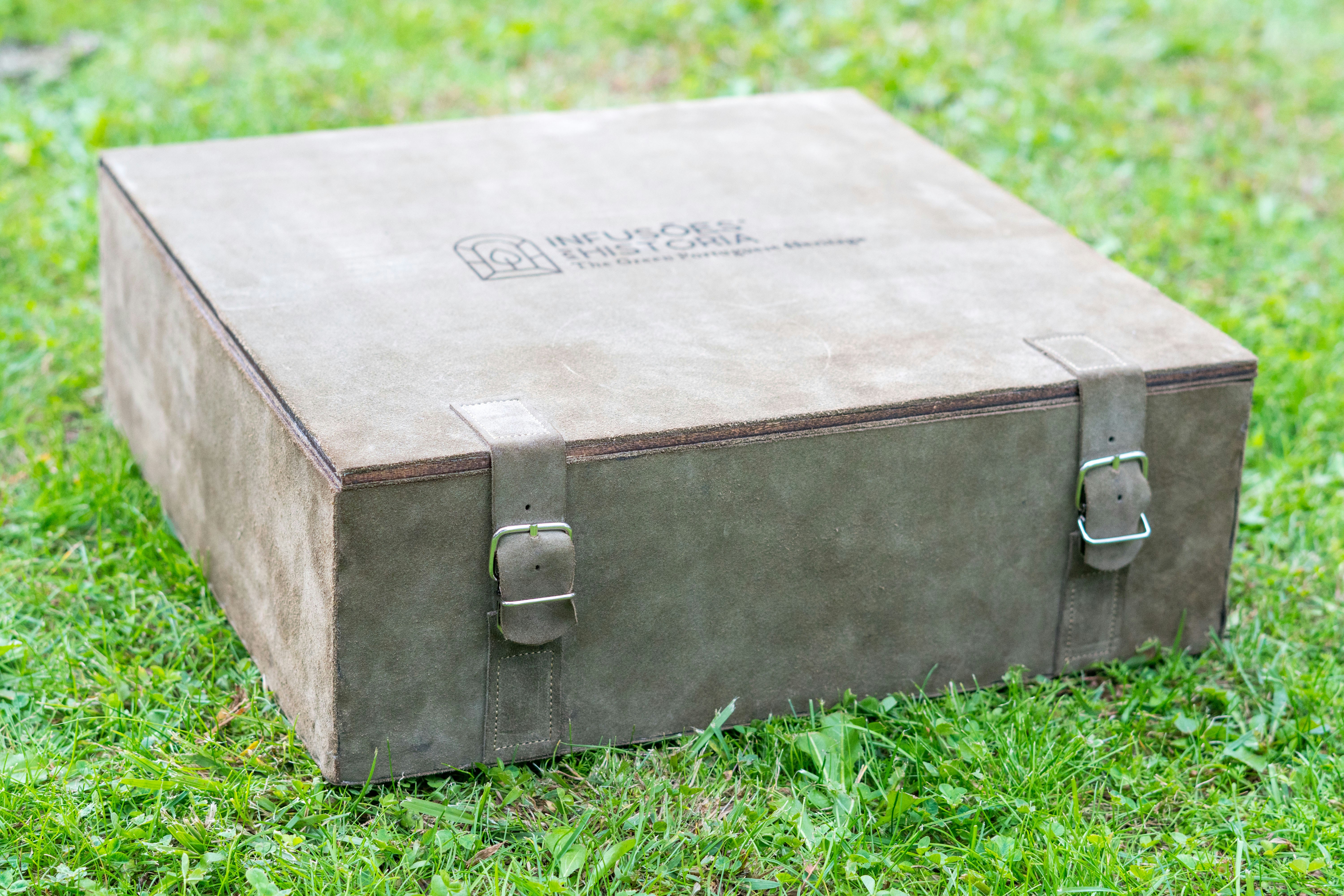 A brown box sitting on top of a lush green field