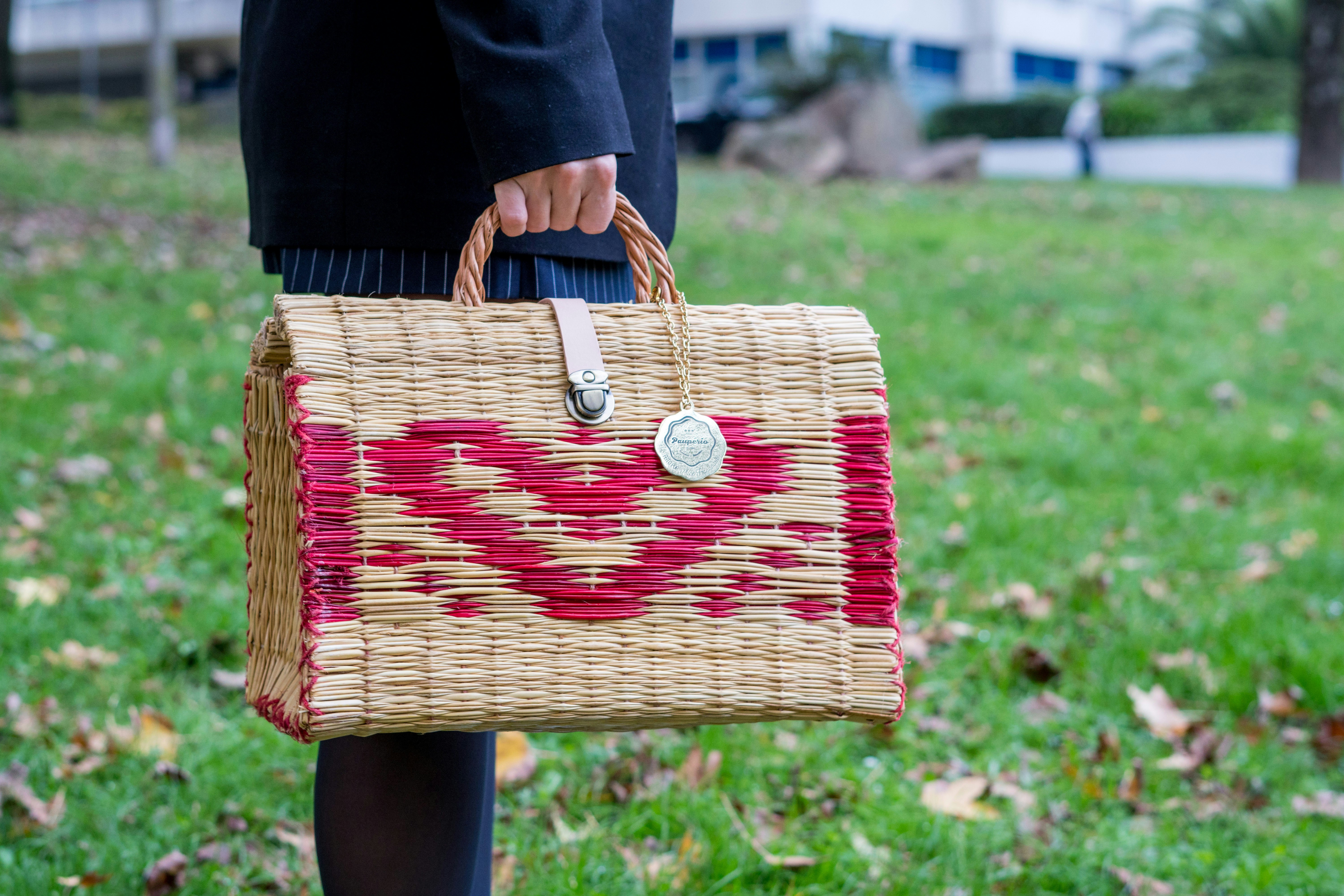 A person holding a woven basket in their hand