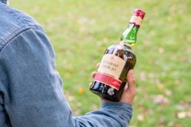 A man holding a bottle of beer in his hand