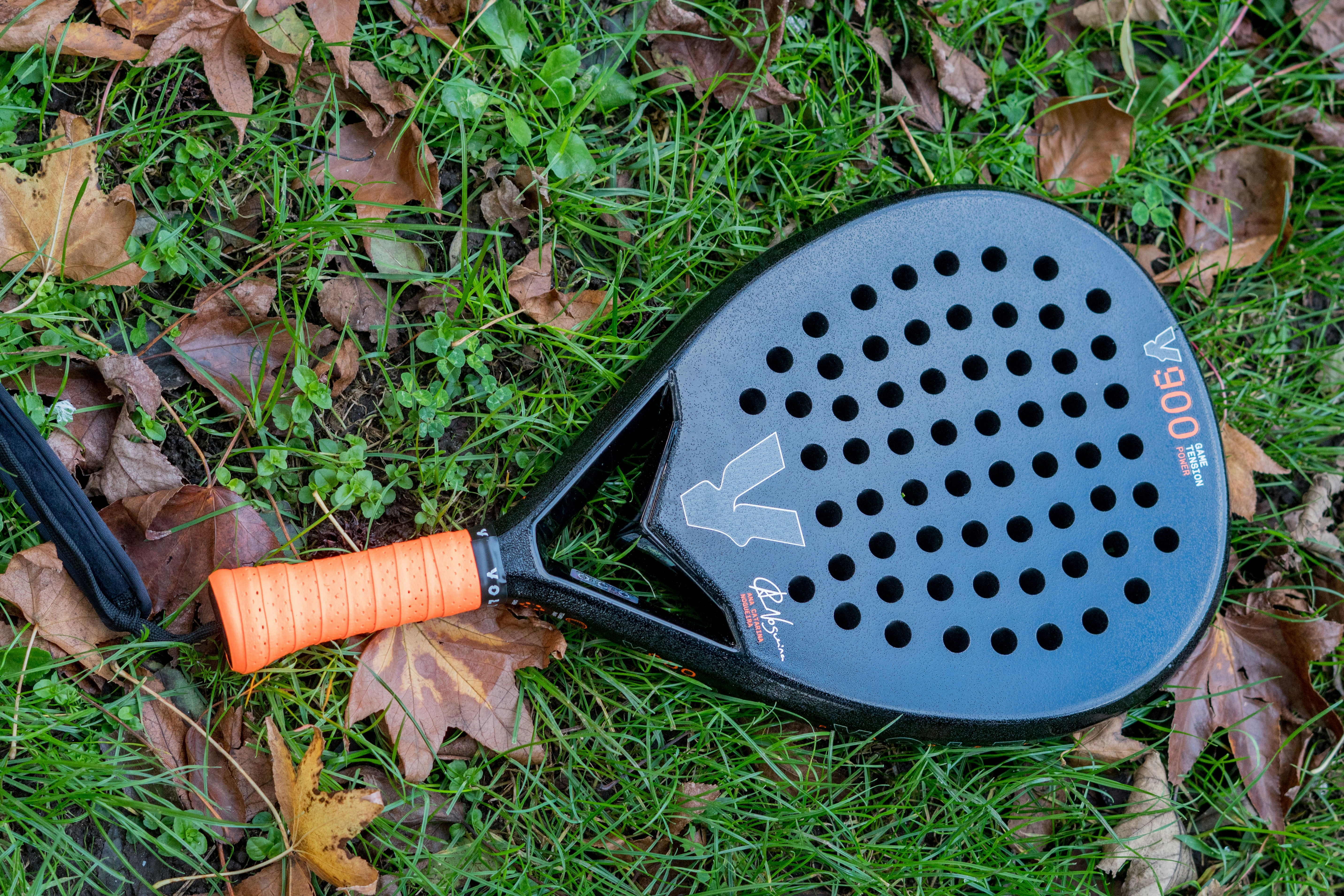A racquet laying on the ground in the grass
