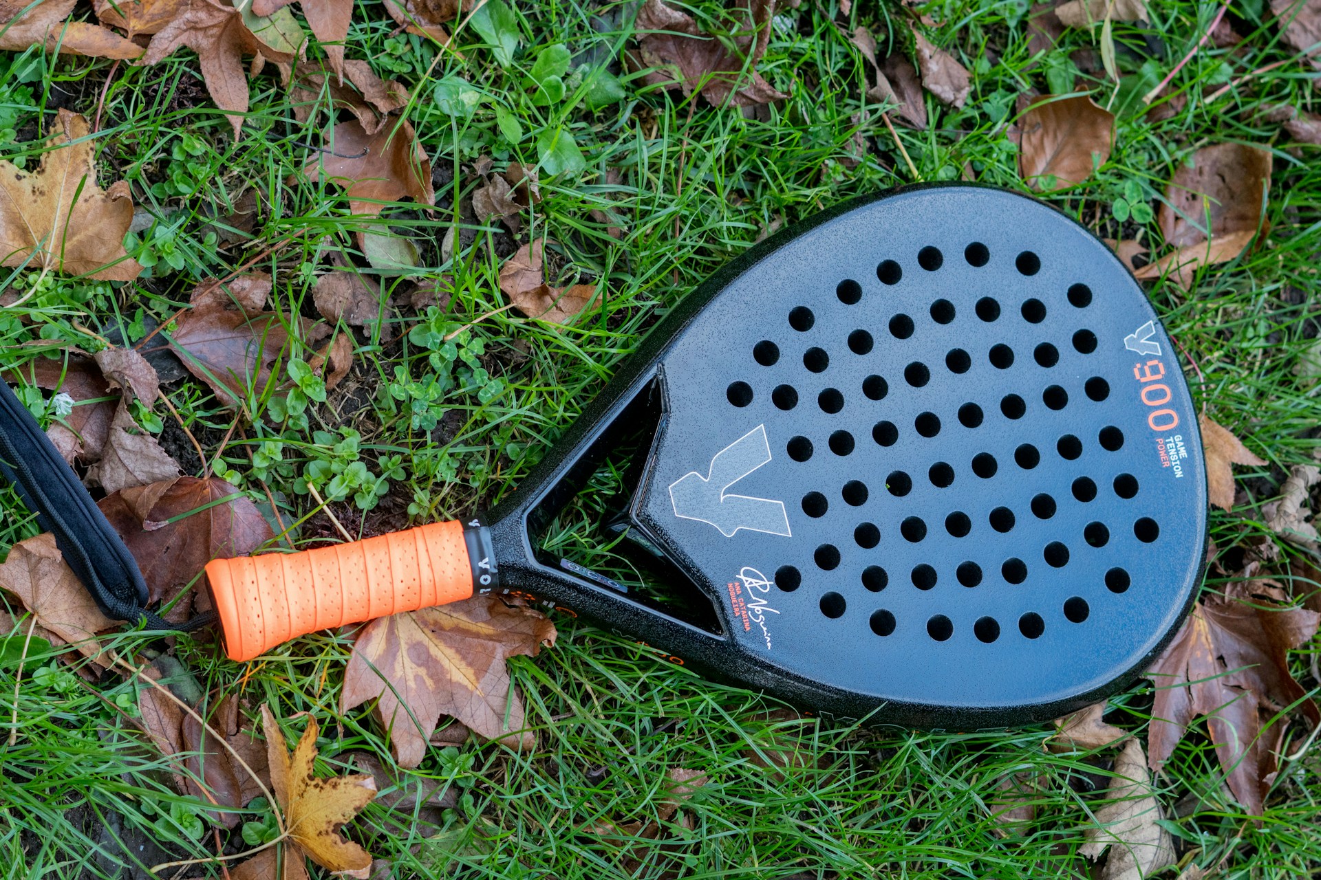 A racquet laying on the ground in the grass