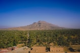 An aerial view of a desert town with a mountain in the background