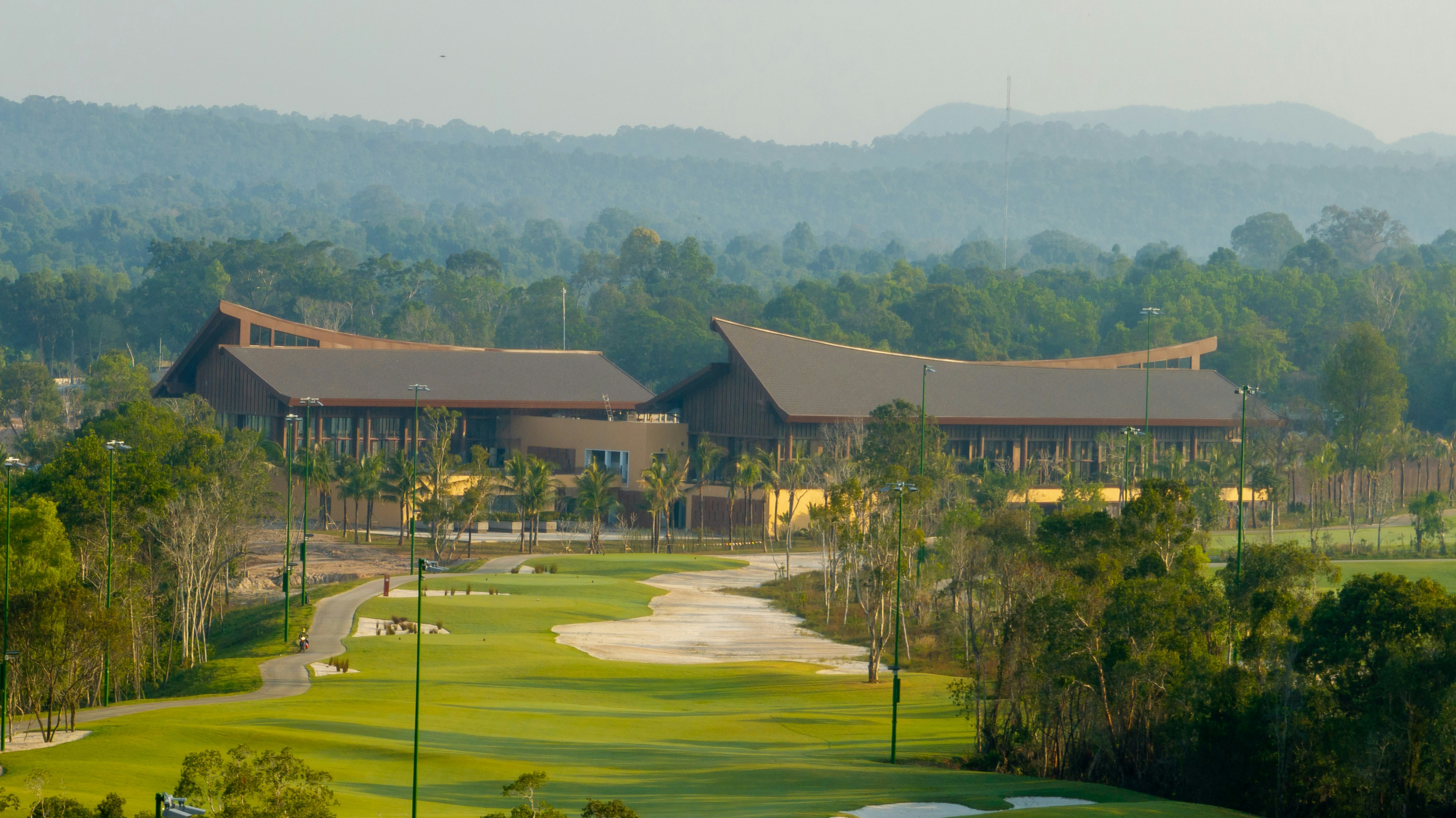 A golf course surrounded by trees and houses