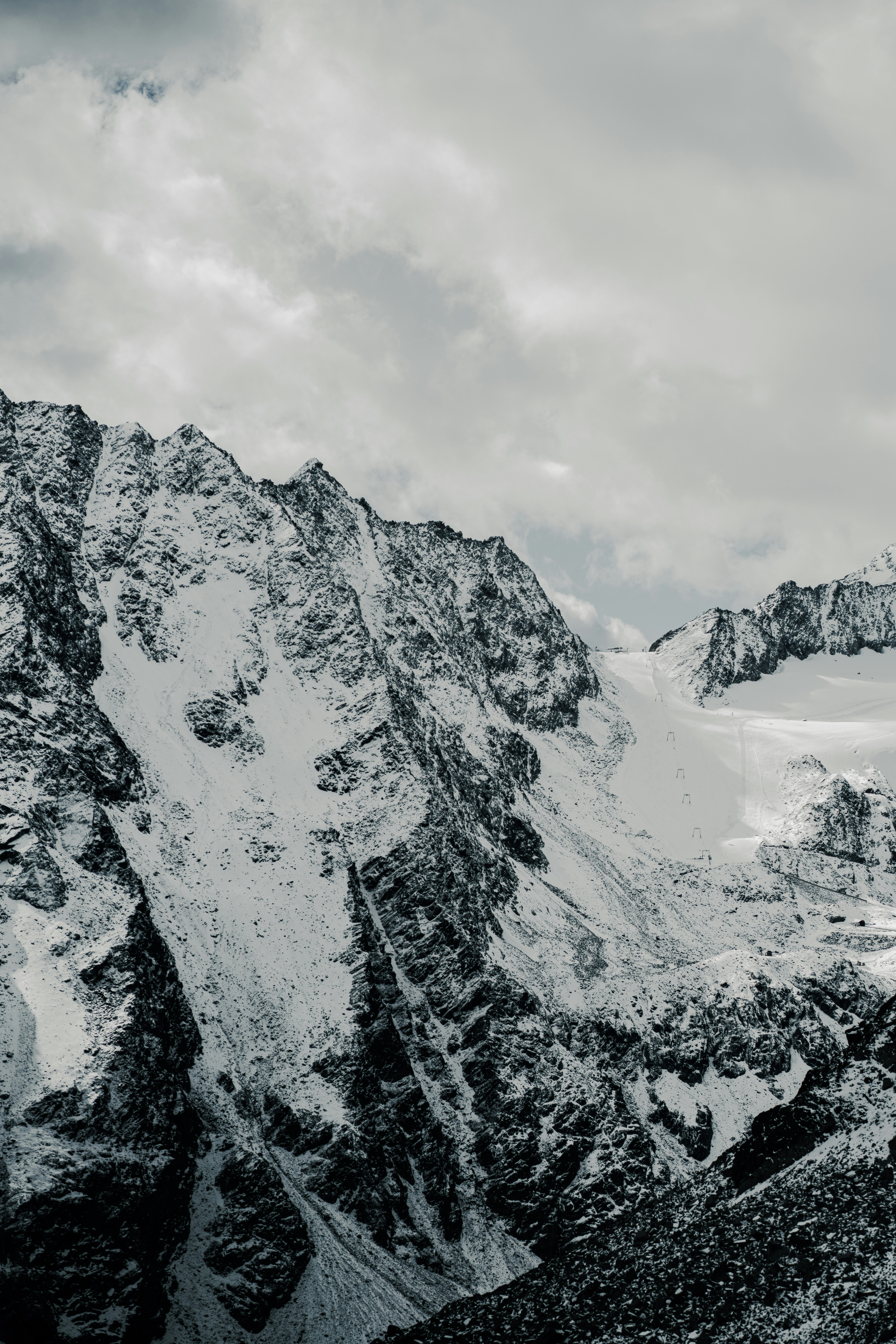A man standing on top of a snow covered mountain