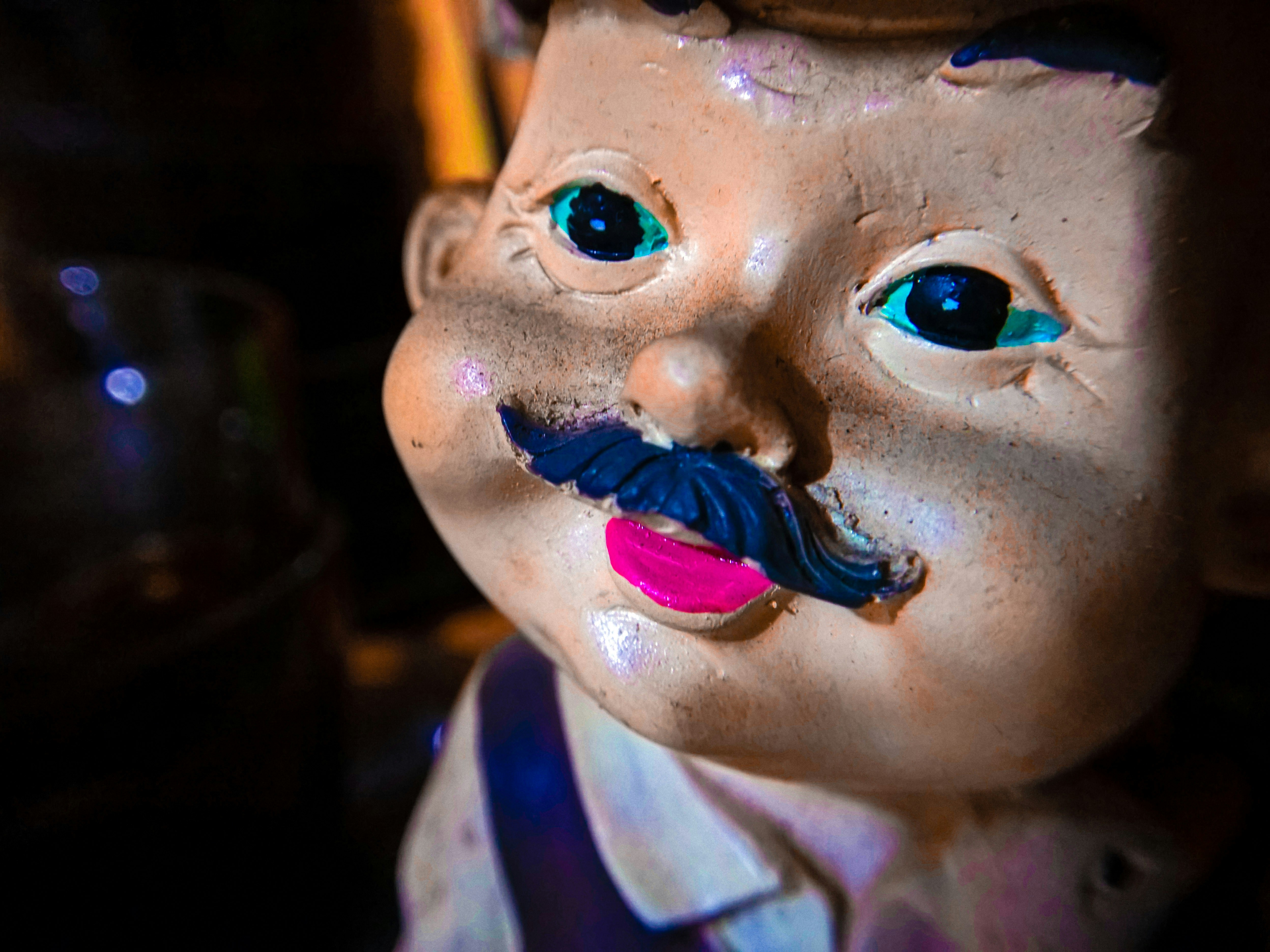 A close up of a statue of a man with a moustache