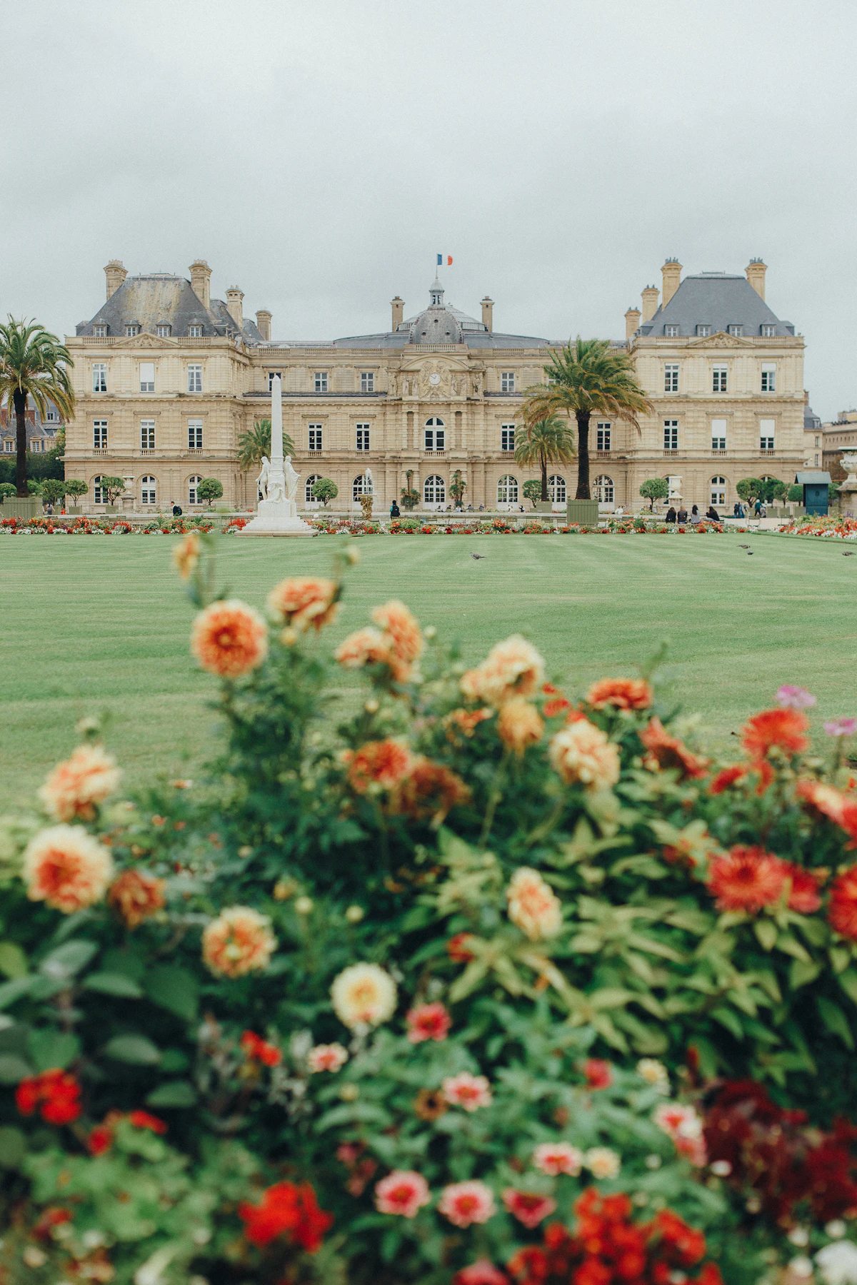 Luxembourg Palace with lawns and colorful flower beds in Paris
