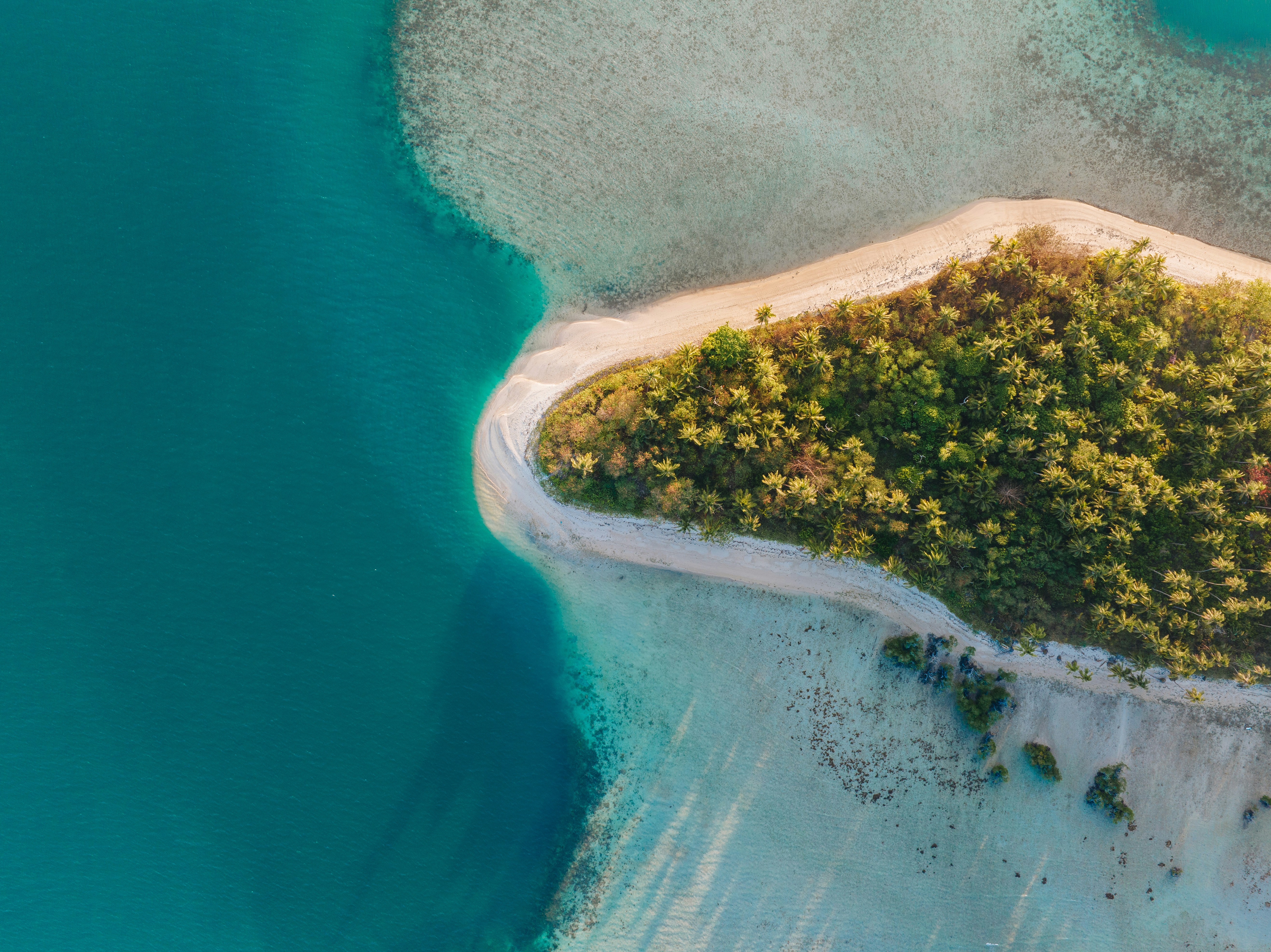 An aerial view of an island in the middle of the ocean, 