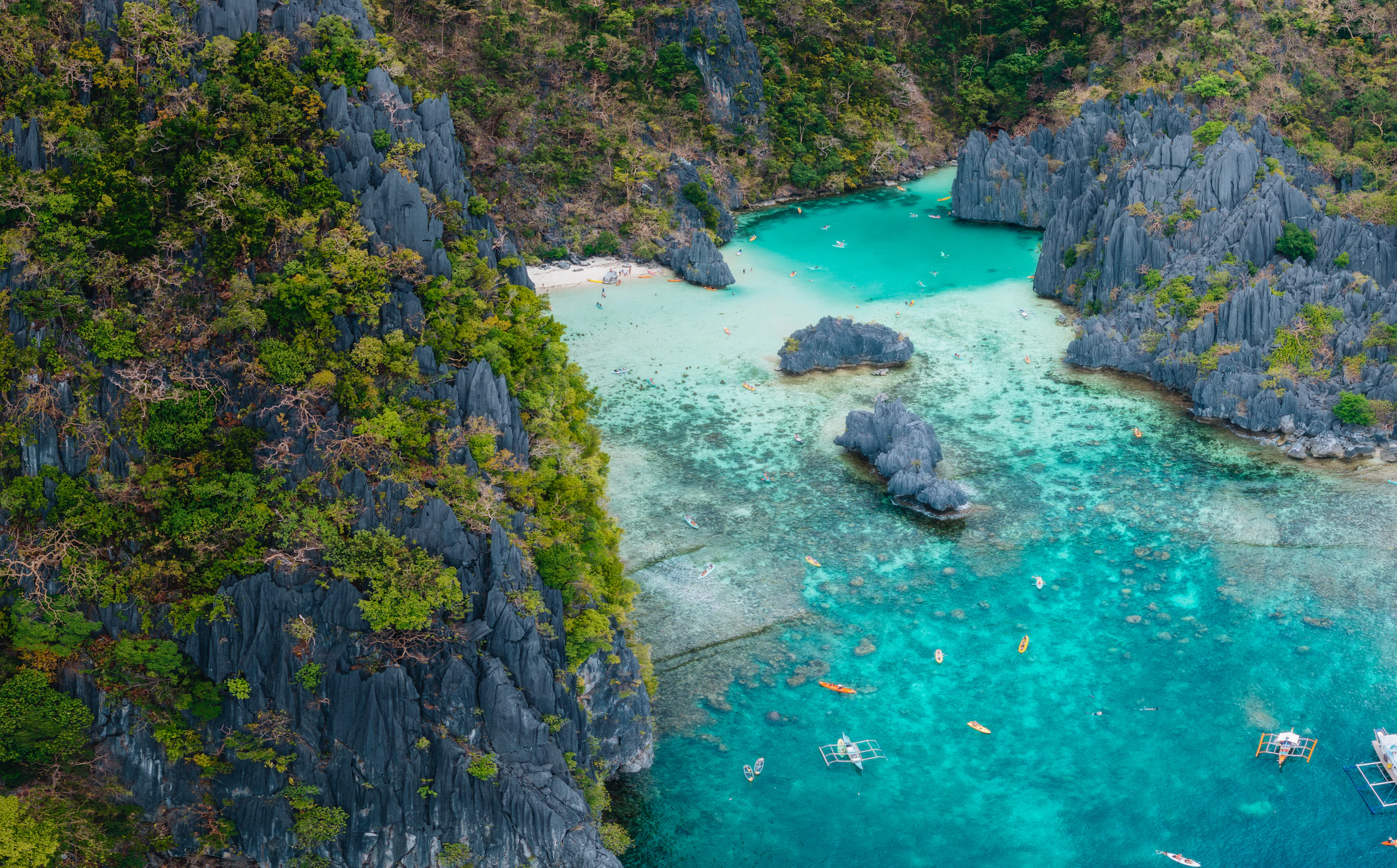 Limestone islands rising from a calm green bay off northern Palawan