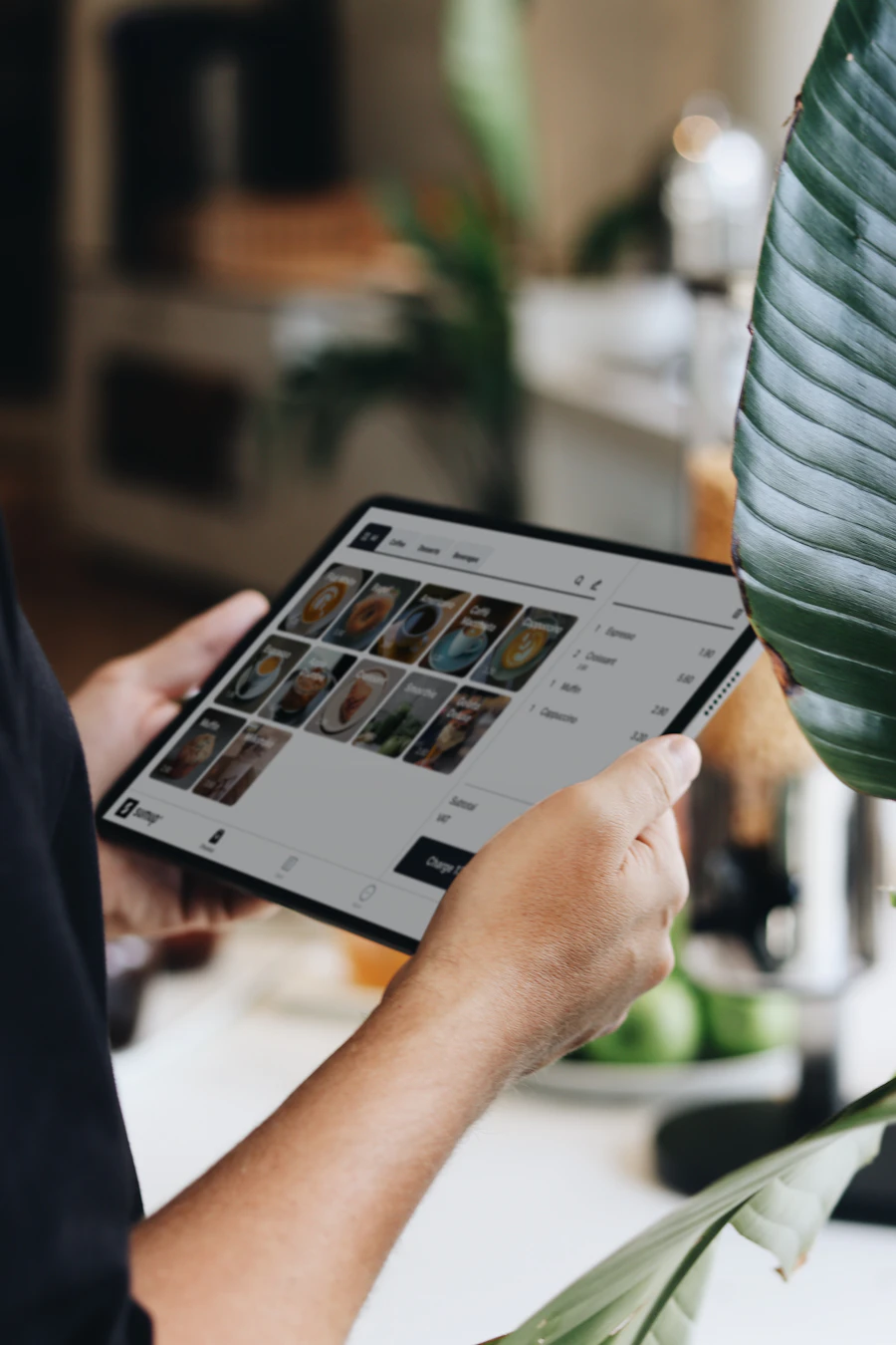 Small business worker reviewing sales and operations on a tablet.