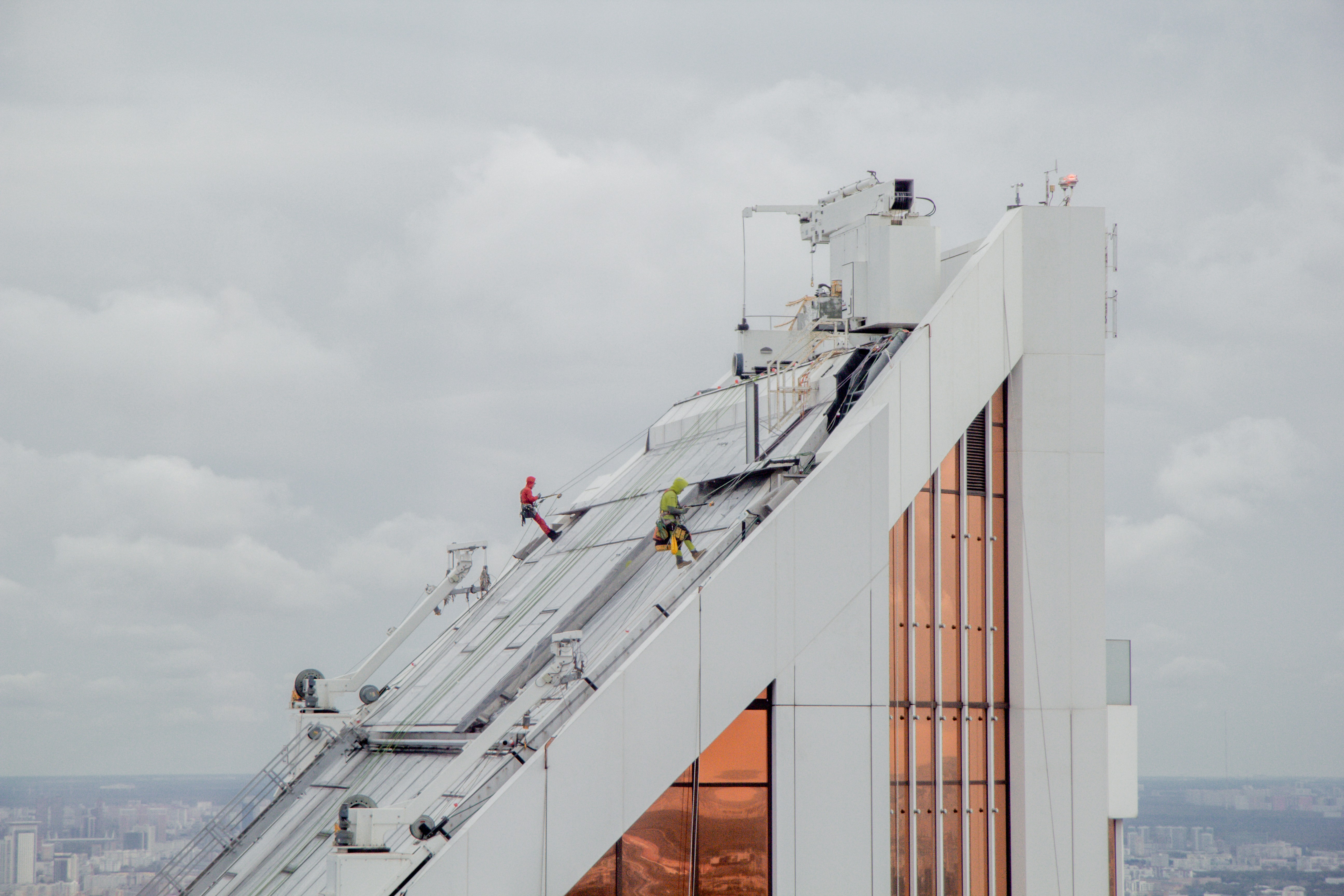 A tall white building with a ladder on top of it