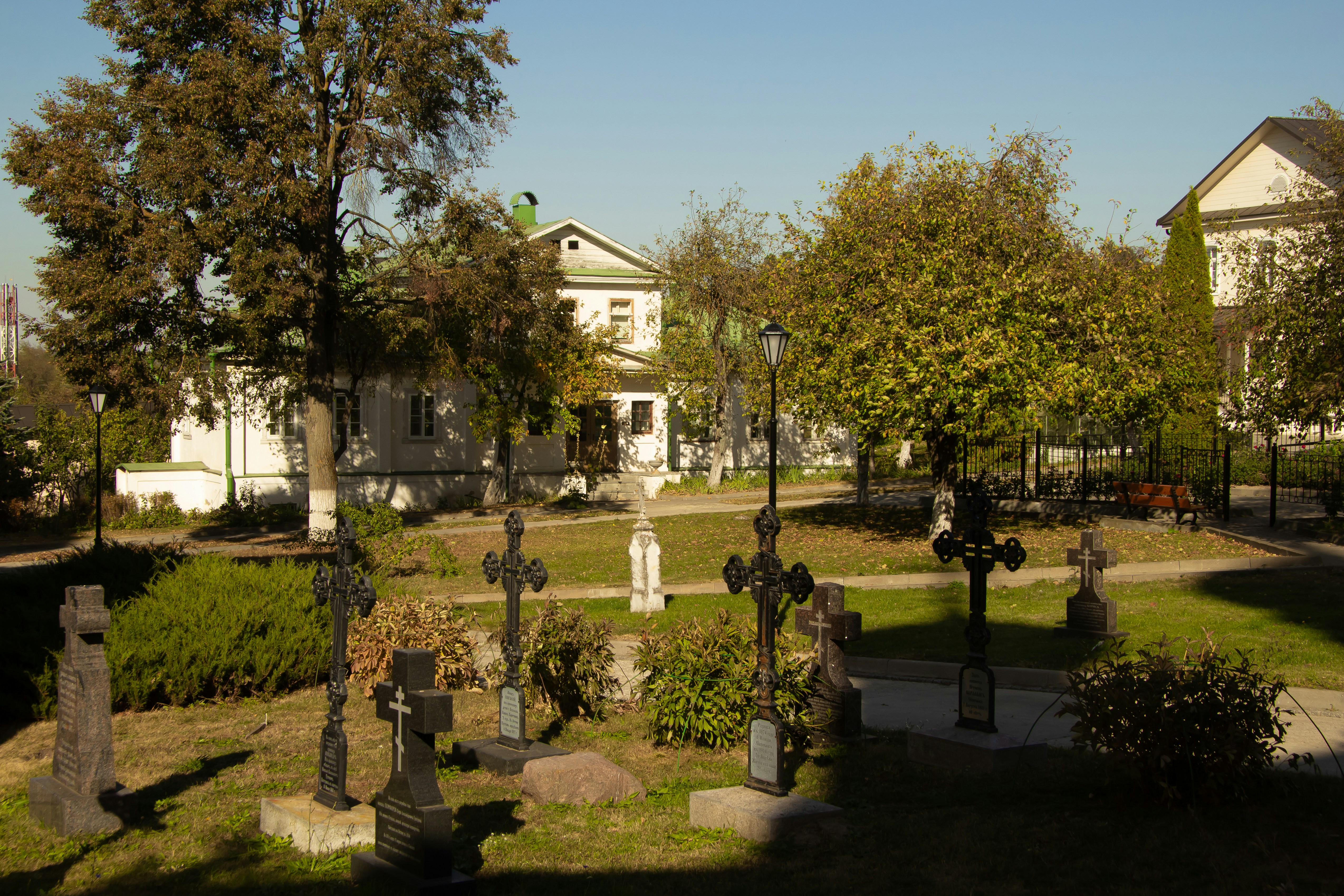 A cemetery with many headstones and trees in the background