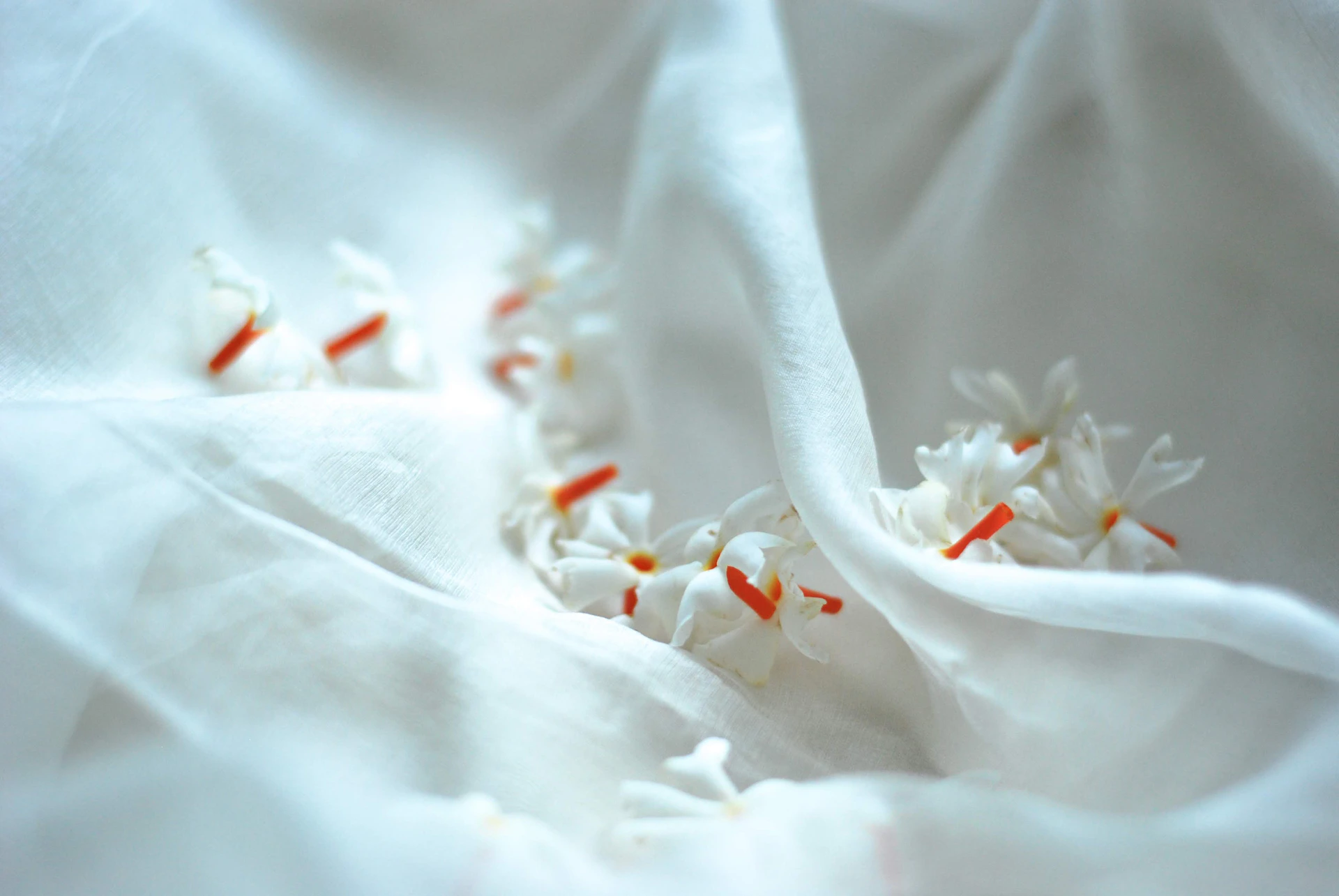 A close up of a white cloth with flowers on it