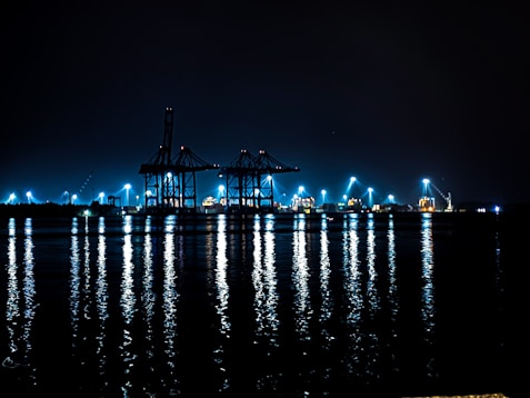 A large body of water filled with lots of lights