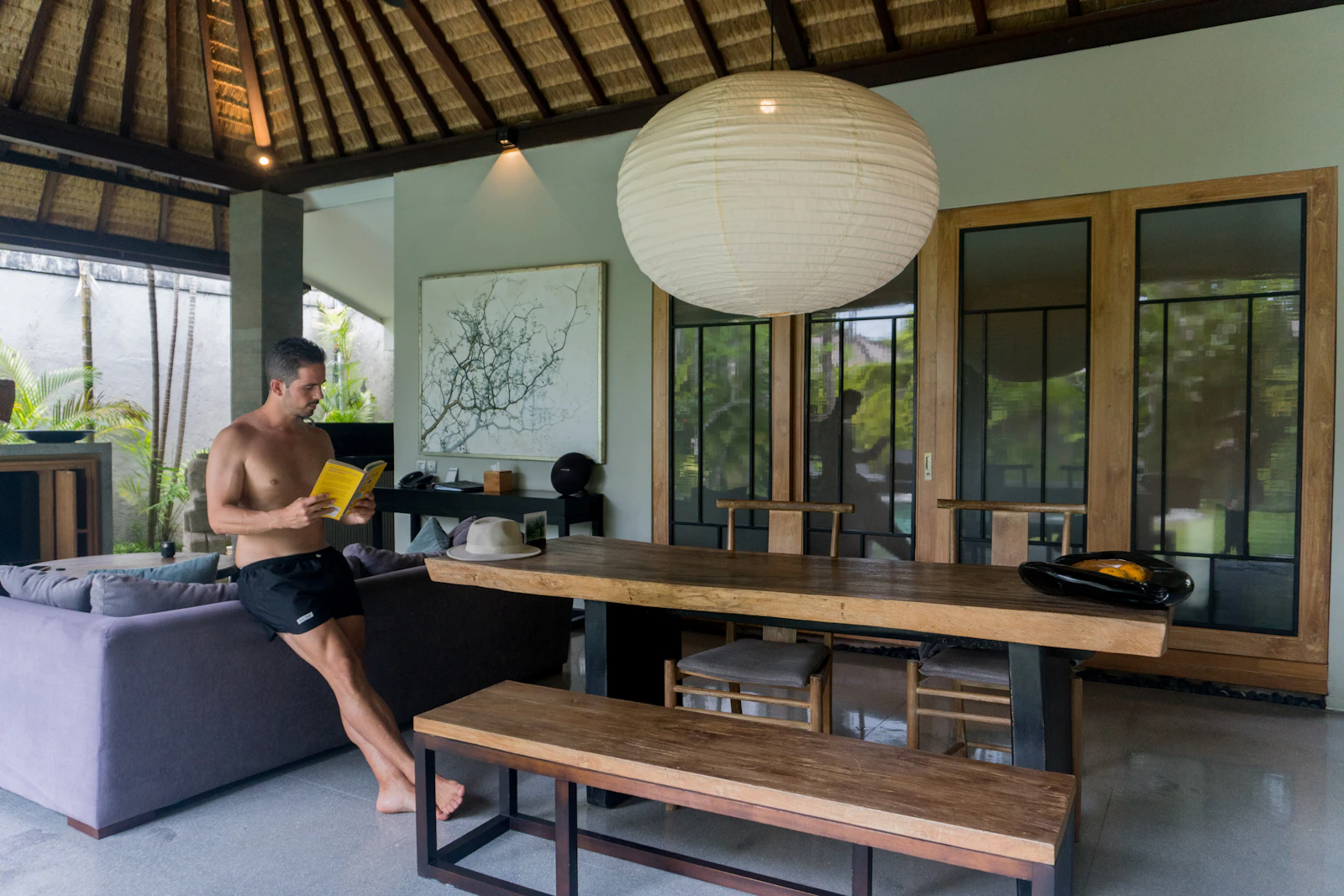 A living room interior with open doors to the outside