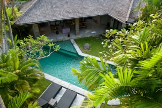 An aerial view of a house with a swimming pool