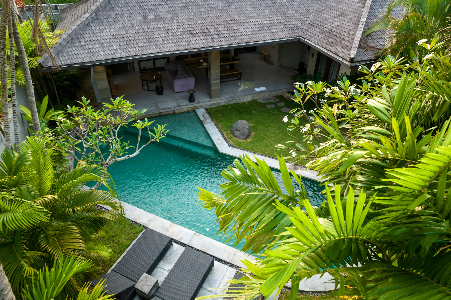 An aerial view of a house with a swimming pool