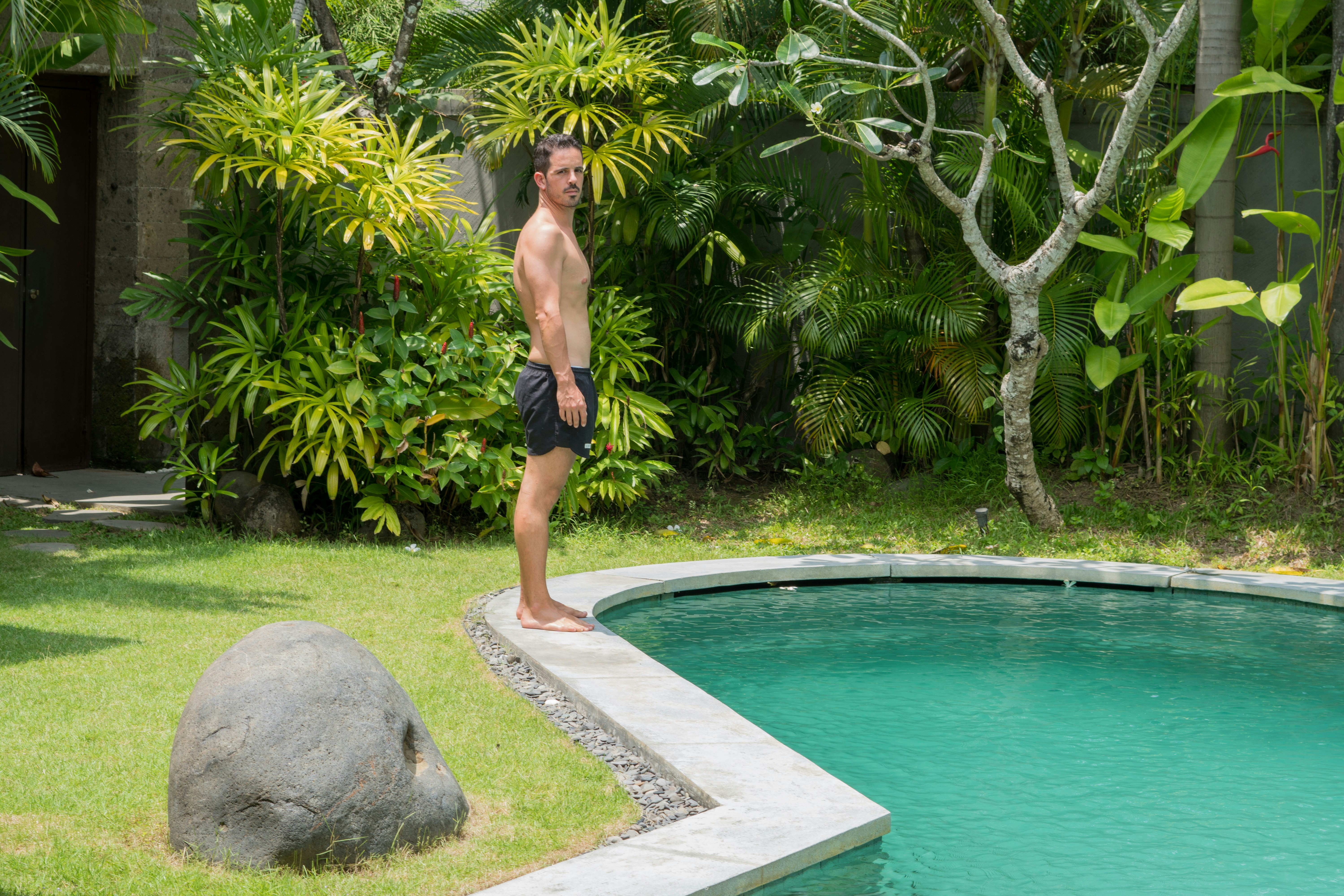 A man standing in front of a swimming pool