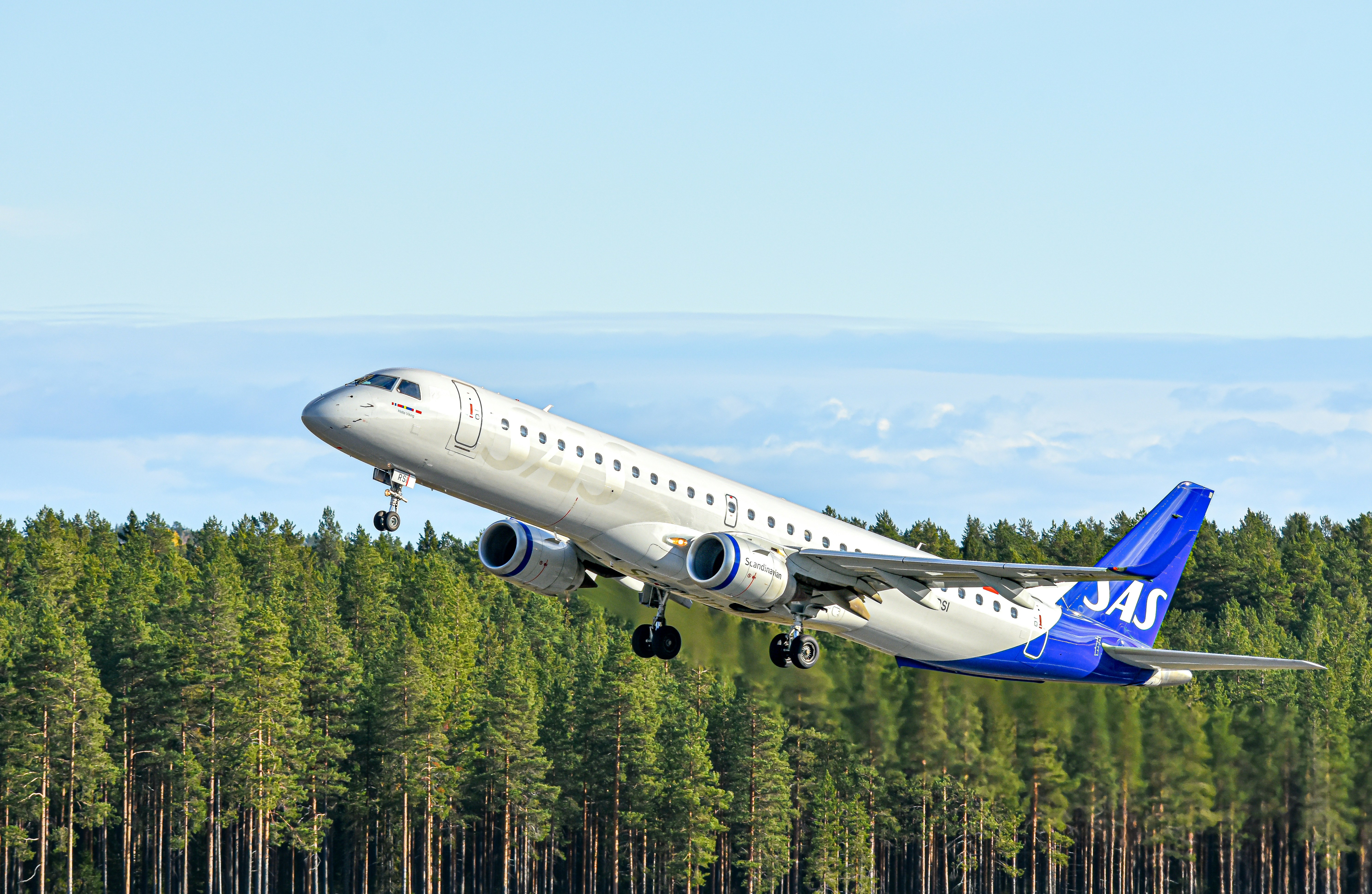 A large passenger jet taking off from an airport runway photo – Free ...