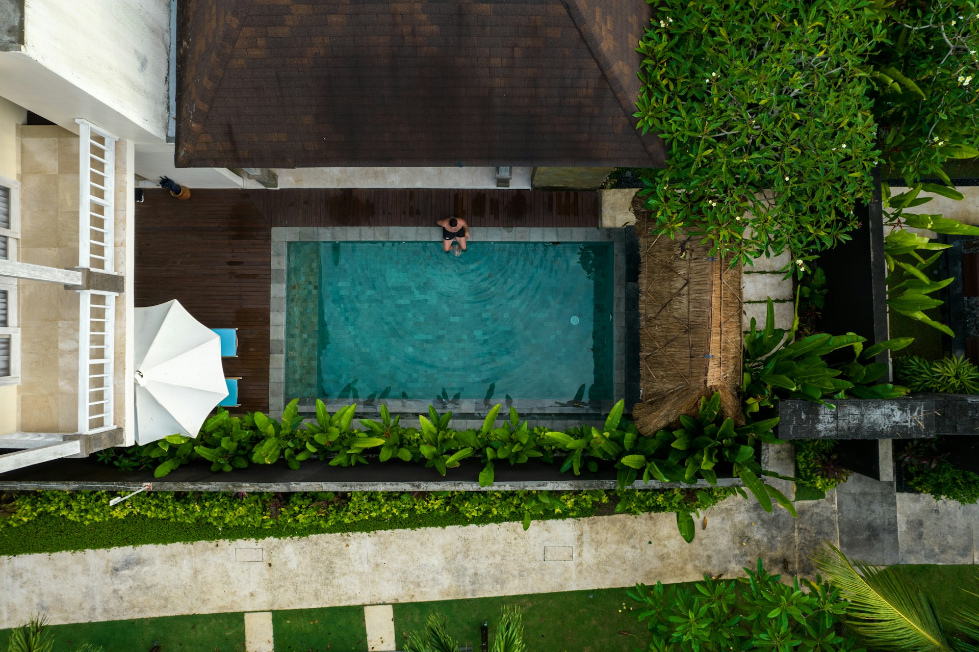 An aerial view of a house with a swimming pool