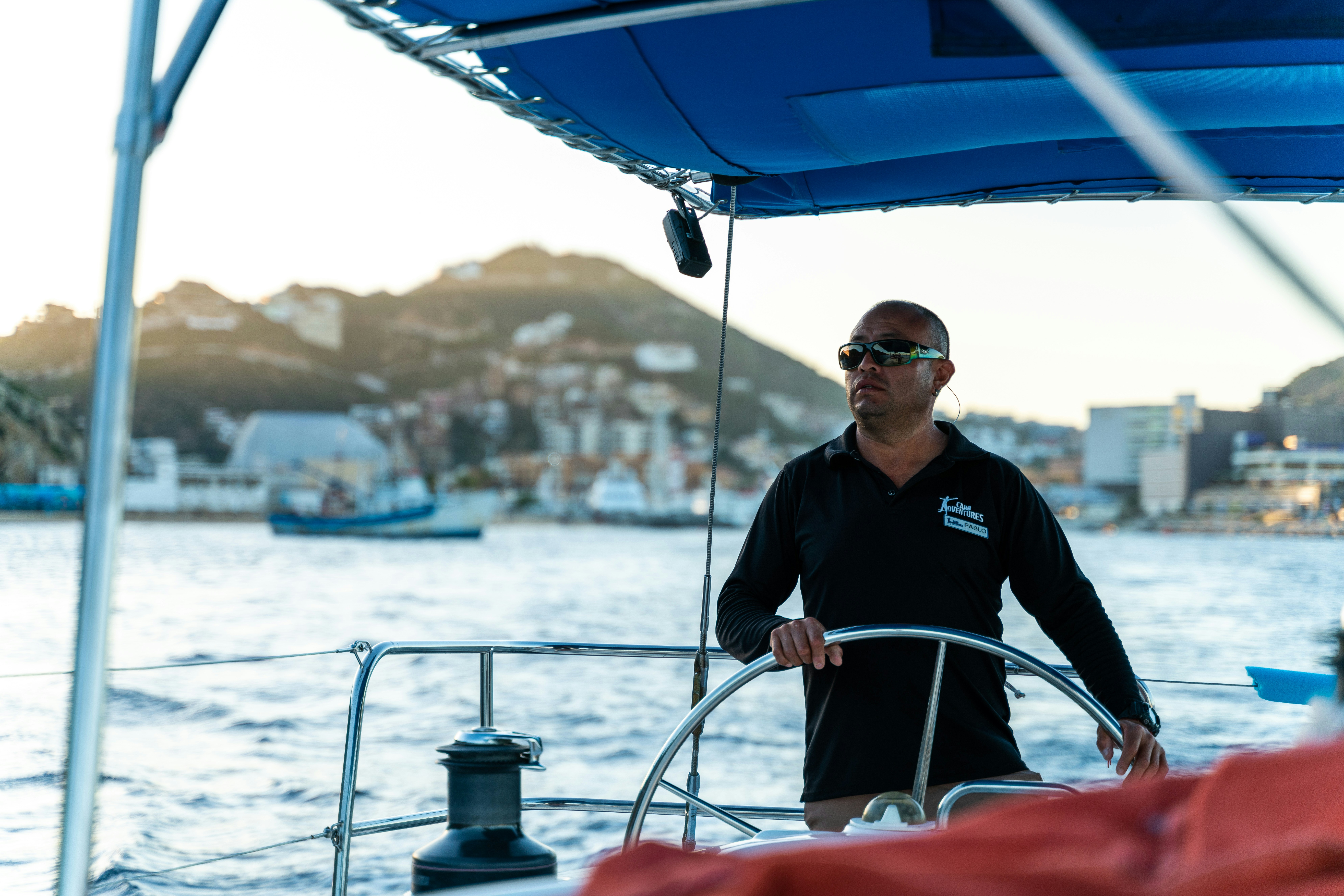 A man standing on a boat in the water