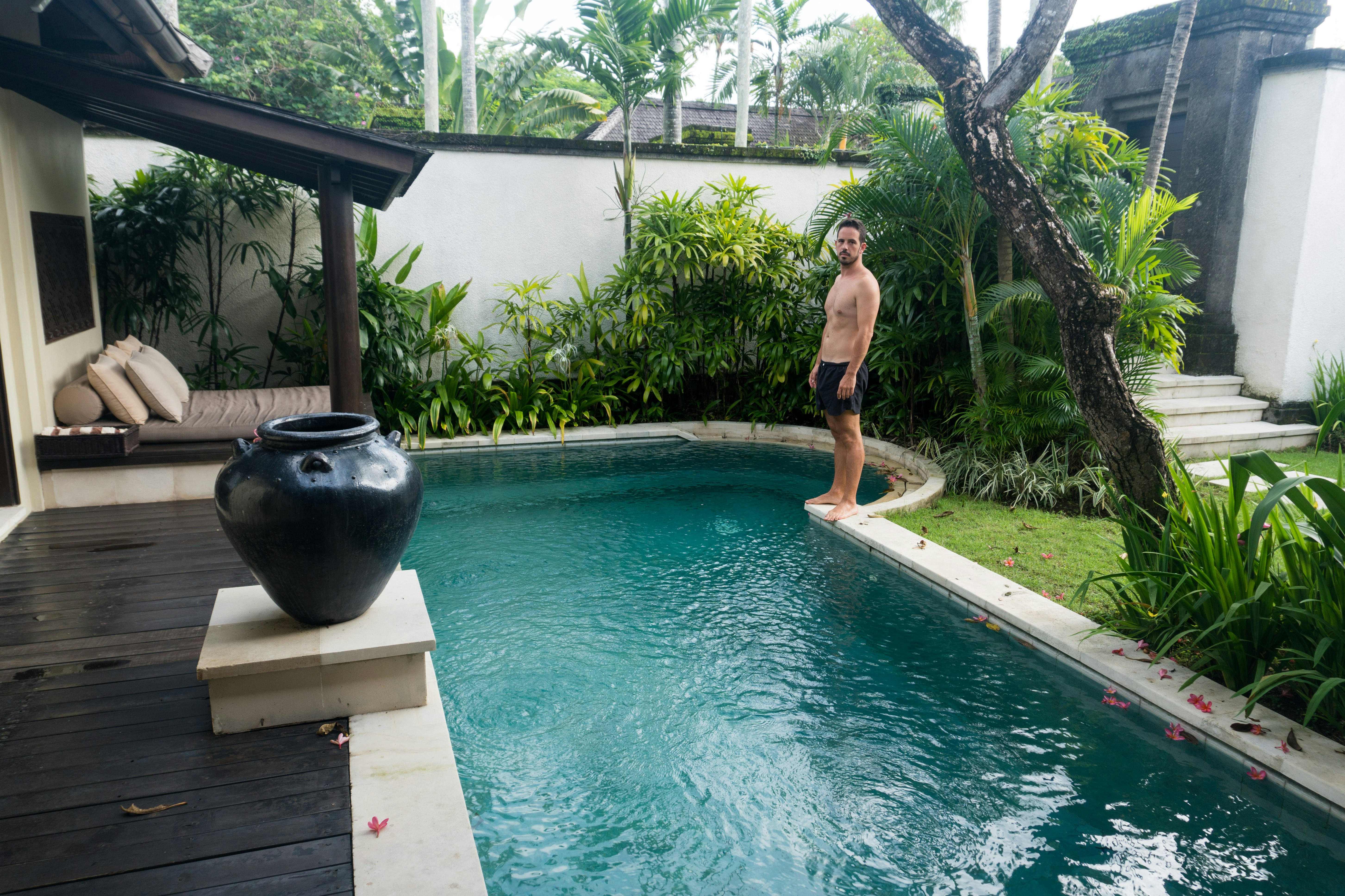 Man standing by swimming pool