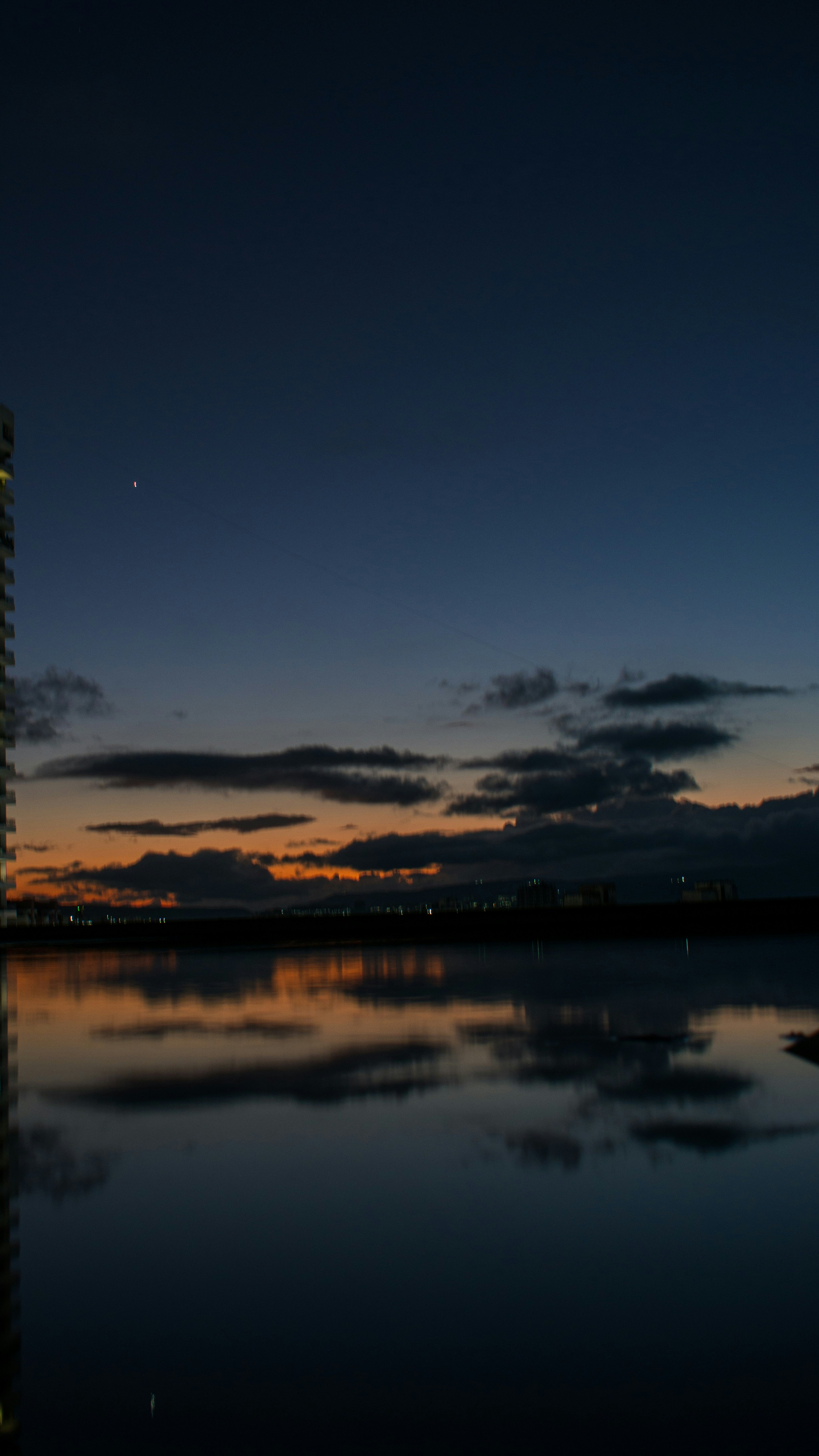 A tall building sitting next to a body of water