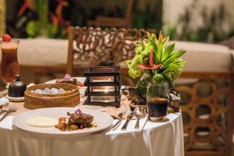 A table topped with a white table cloth covered table