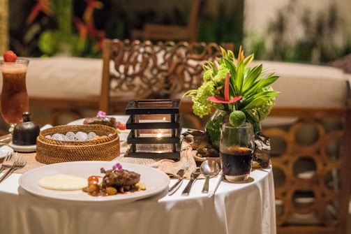 A table topped with a white table cloth covered table