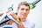 A man holding onto a blue and yellow surfboard