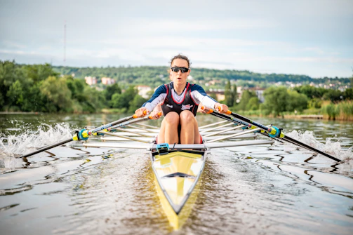 A man riding a boat on top of a body of water