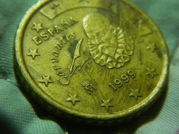 A close up of a gold coin with stars on it