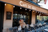 A teddy bear sitting in the window of a cafe