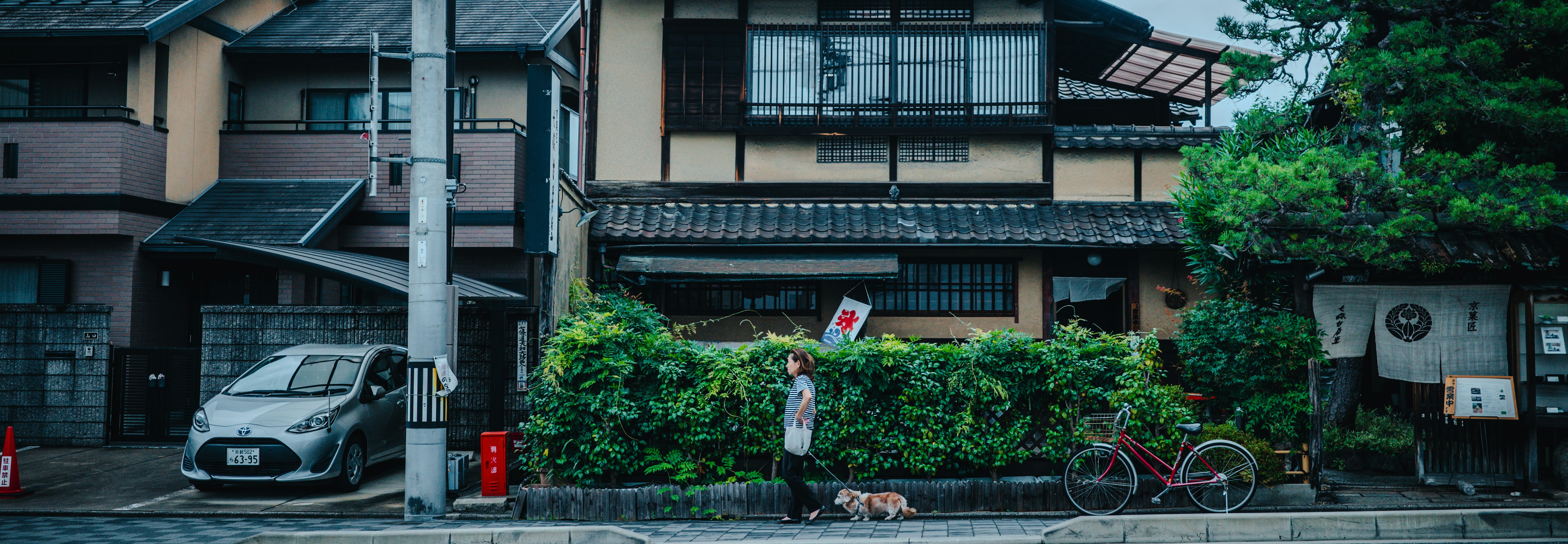 A car parked in front of a house on a rainy day