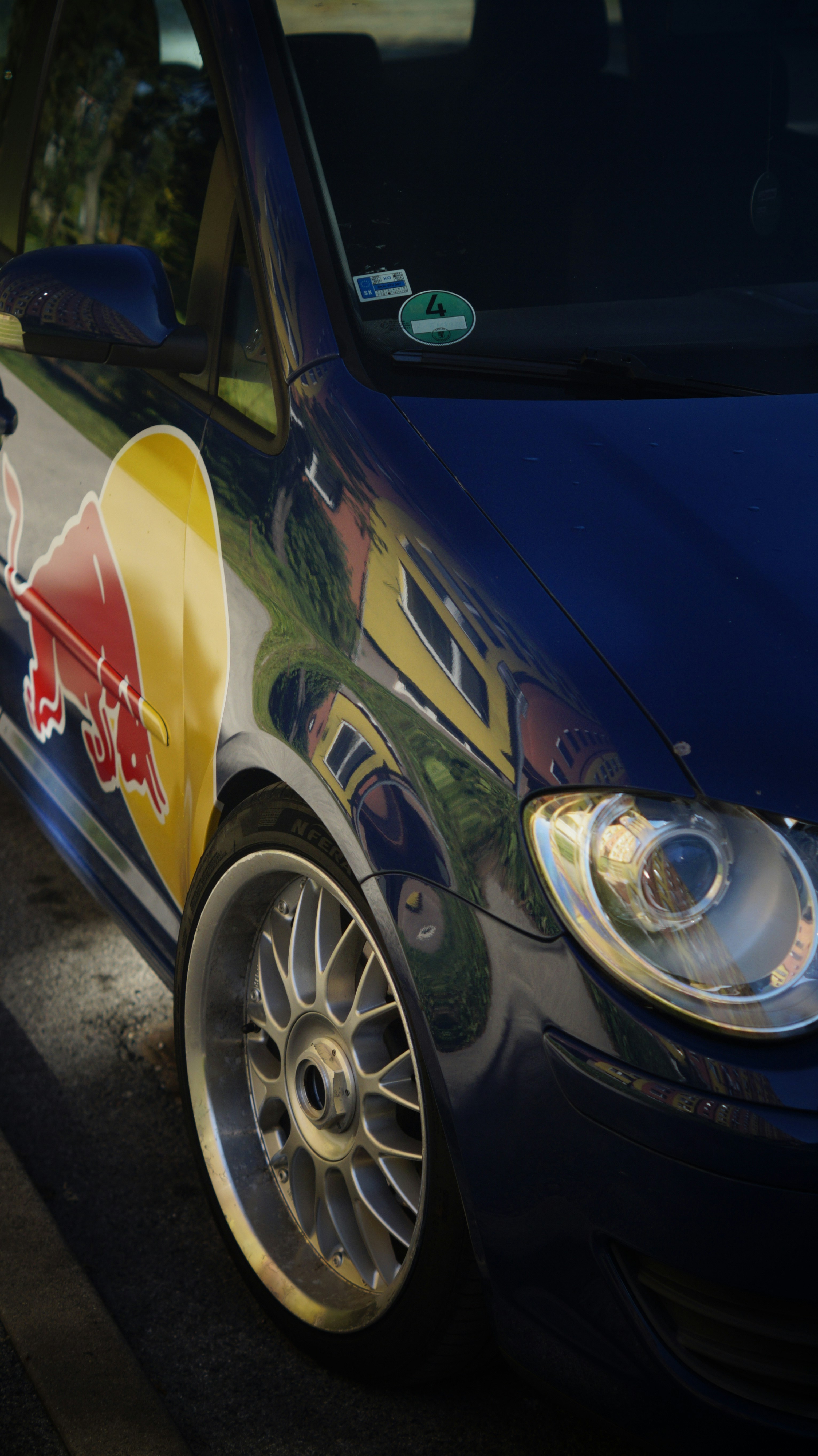 A blue car with a red bull painted on it