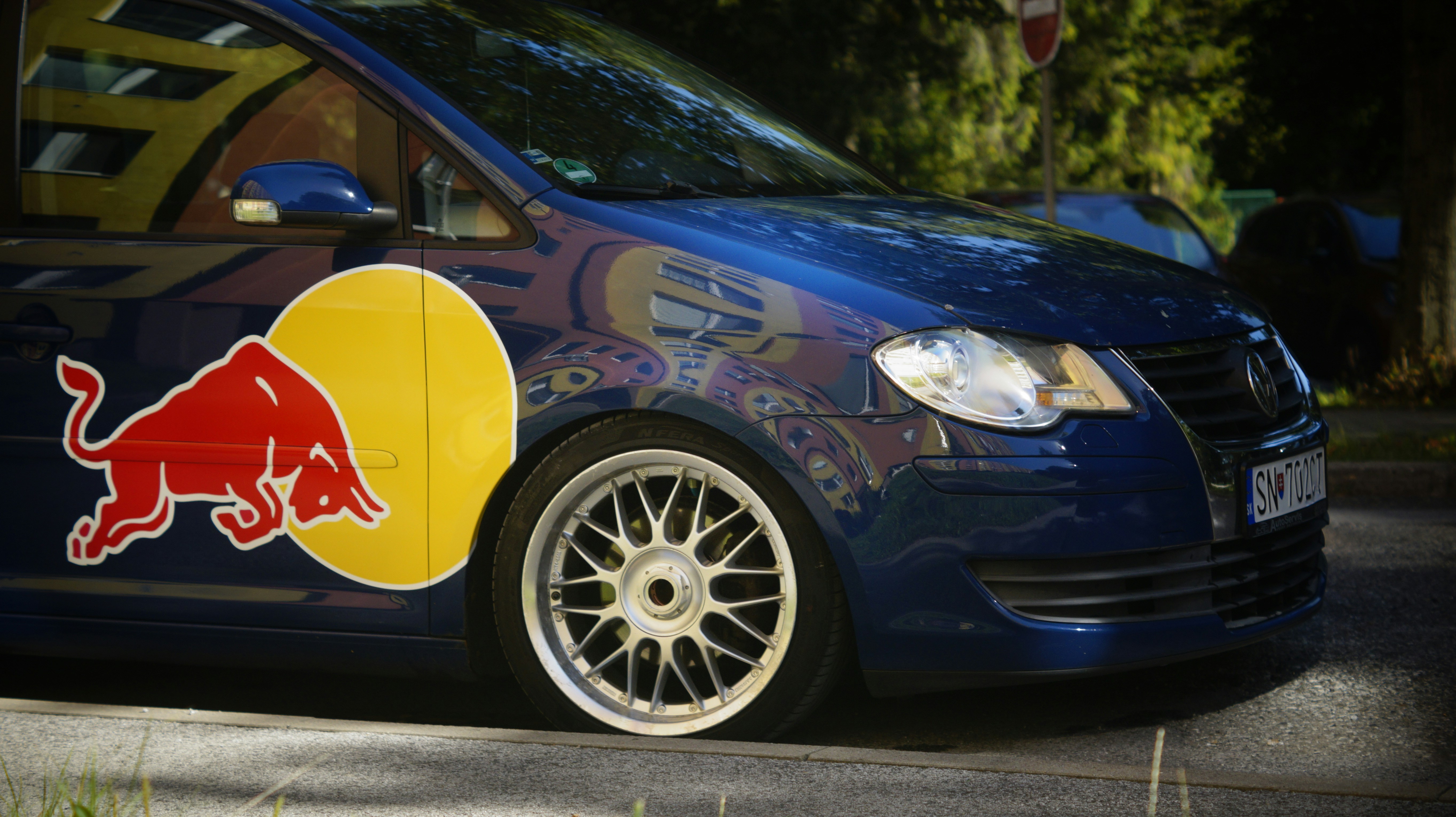 A blue van with a red bull painted on it